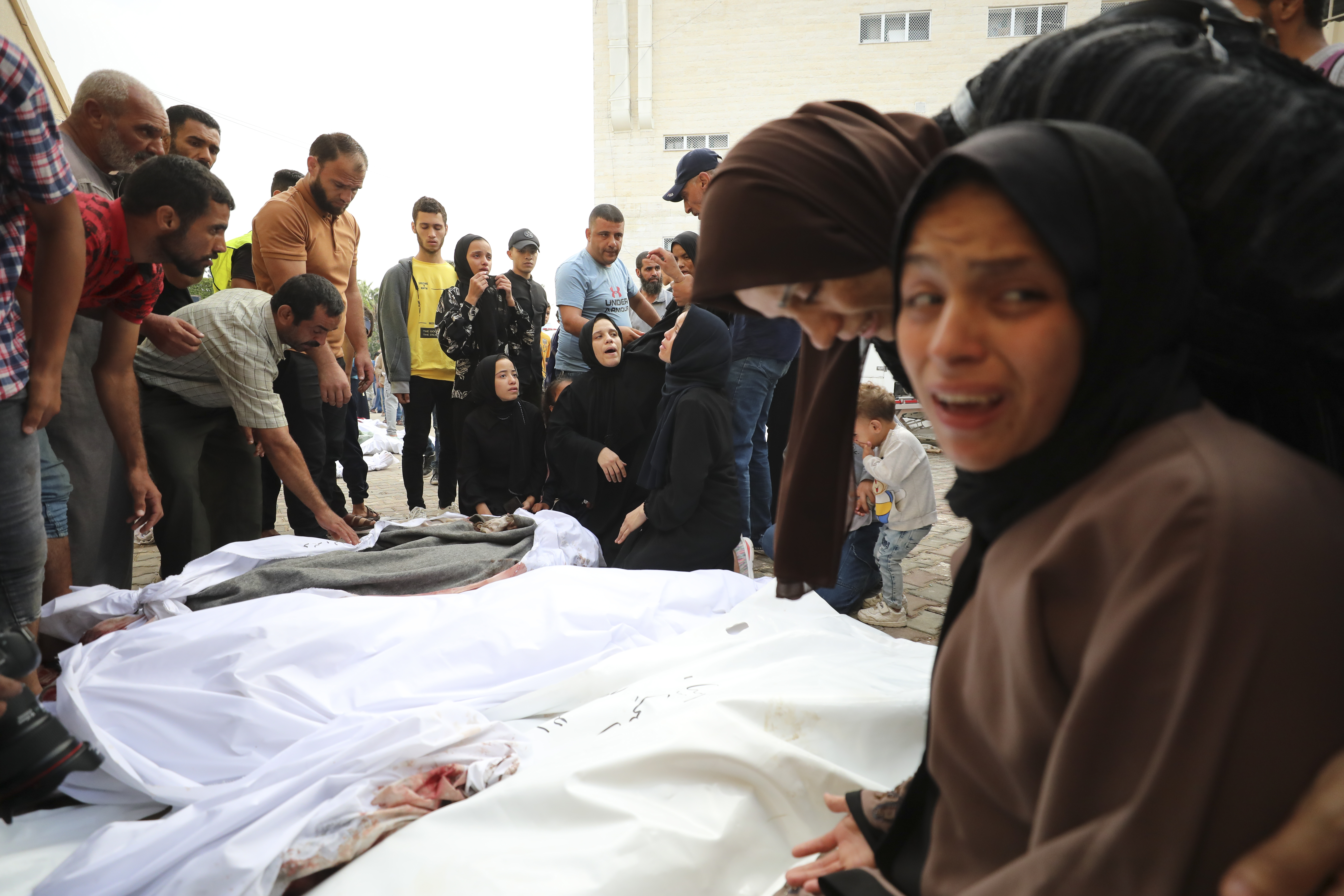 Palestinians mourn relatives killed in the Israeli bombardment in Al-Aqsa Hospital in Deir Al-Balah, south of the Gaza Strip, Monday, Oct. 23, 2023 [Ali Mohmoud/AP Photo]