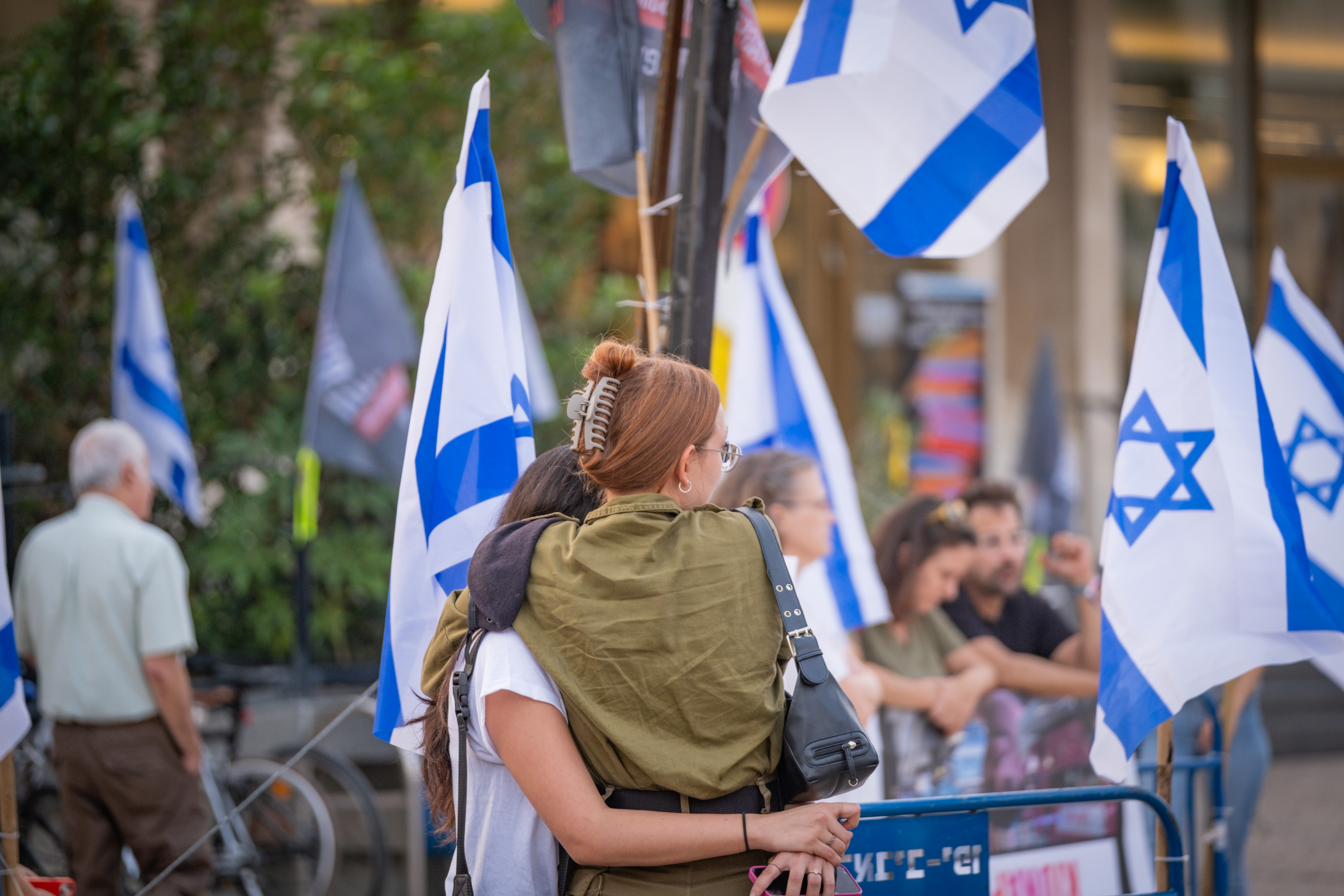 Two protesters with their arms wrapped around each other