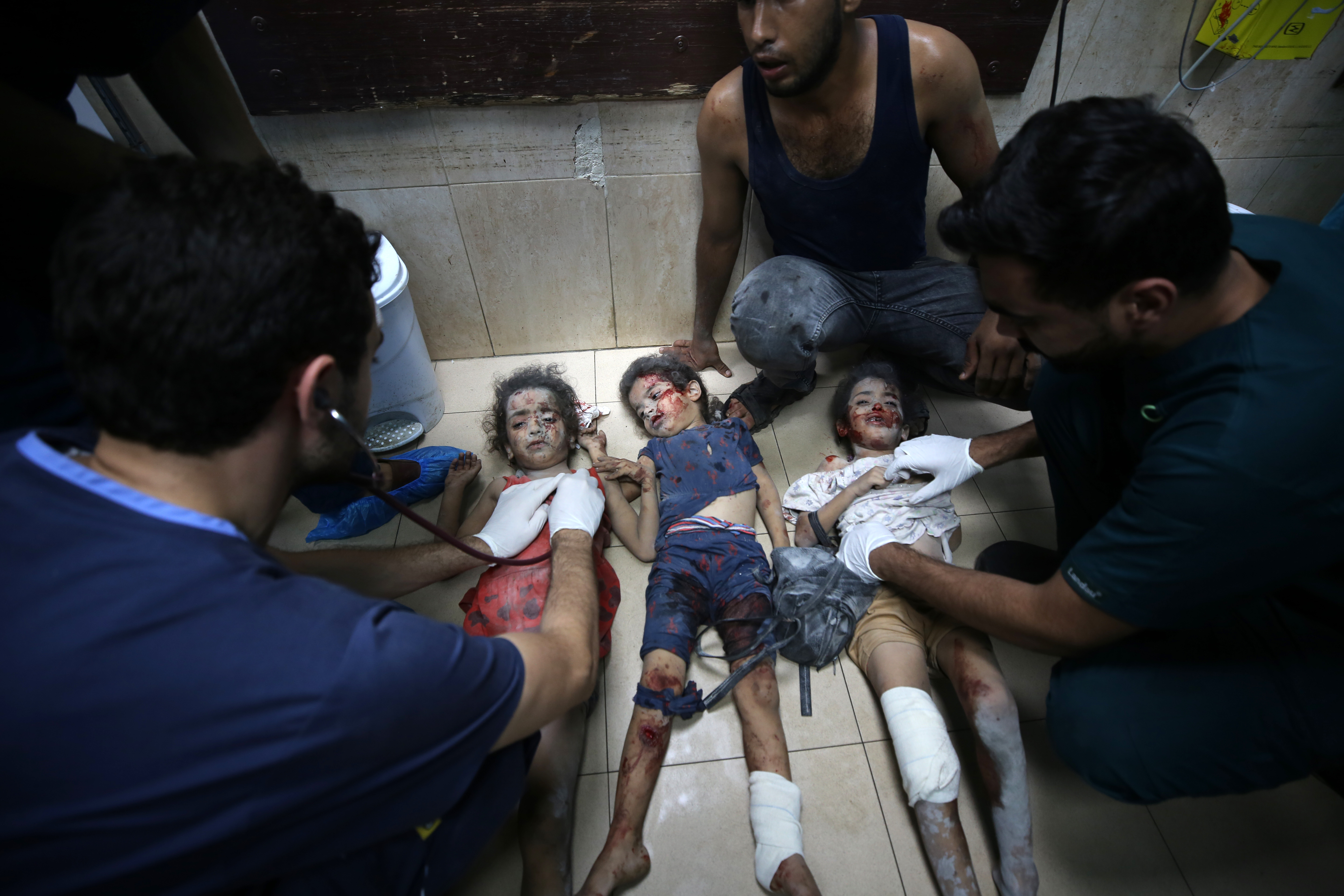 Medics treat three wounded Palestinian children at Al-Aqsa Hospital following an Israeli air attack, in Deir el-Balah in the central Gaza Strip on October 24 [Majdi Fathi/NurPhoto via Getty Images]