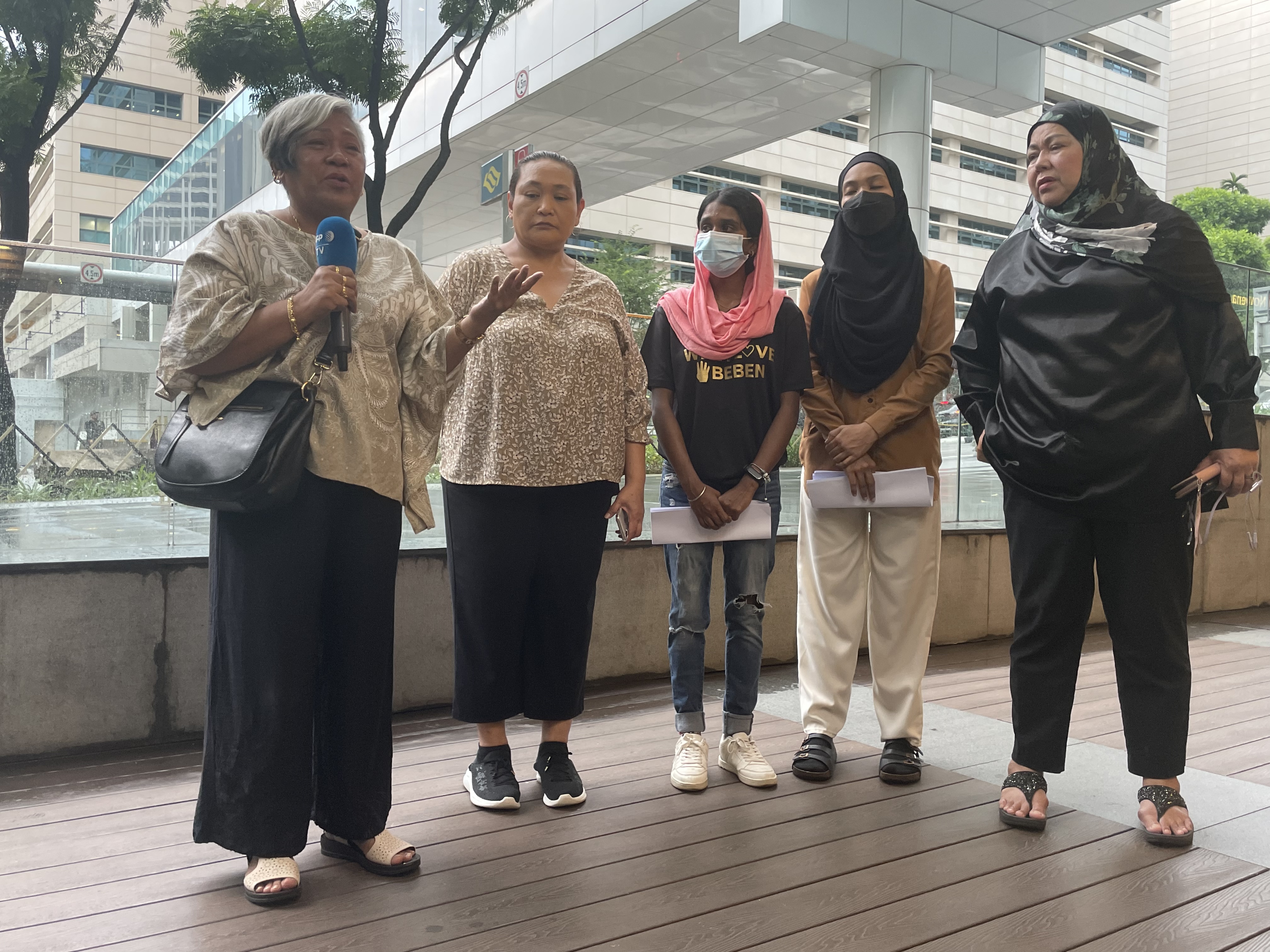 Five family members speaking to the media. They are all women.