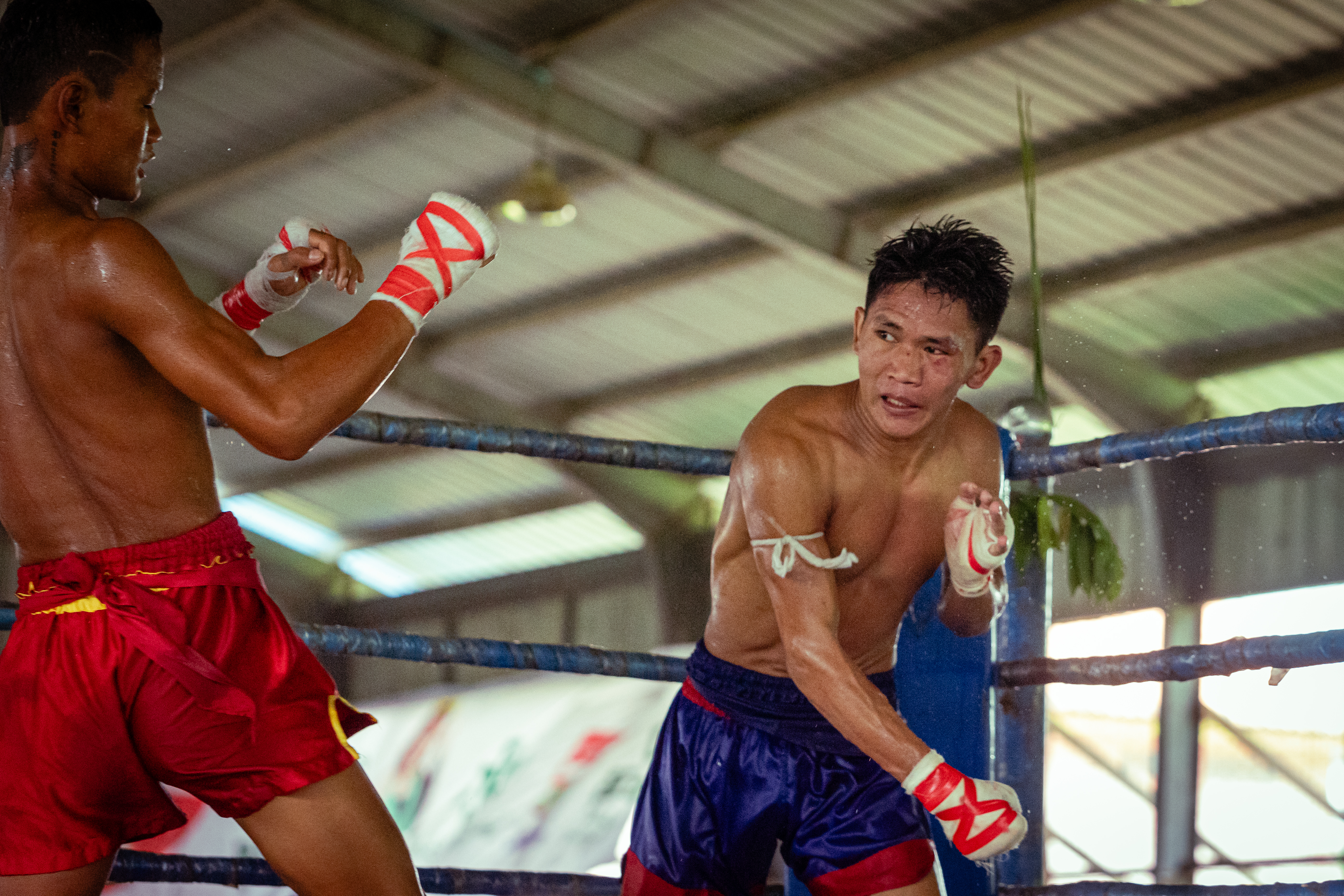 Zaw Du La Mashi, a Kachin fighter known to his friends as “Aung La” due to his resemblance to Myanmar world champion mixed martial arts fighter Aung La N’Sang works his opponent back towards the ropes. With neither fighter achieving a knockout, his bout is declared a draw, earning each 40,000 Myanmar kyats ($12) on top of any tips from the audience.