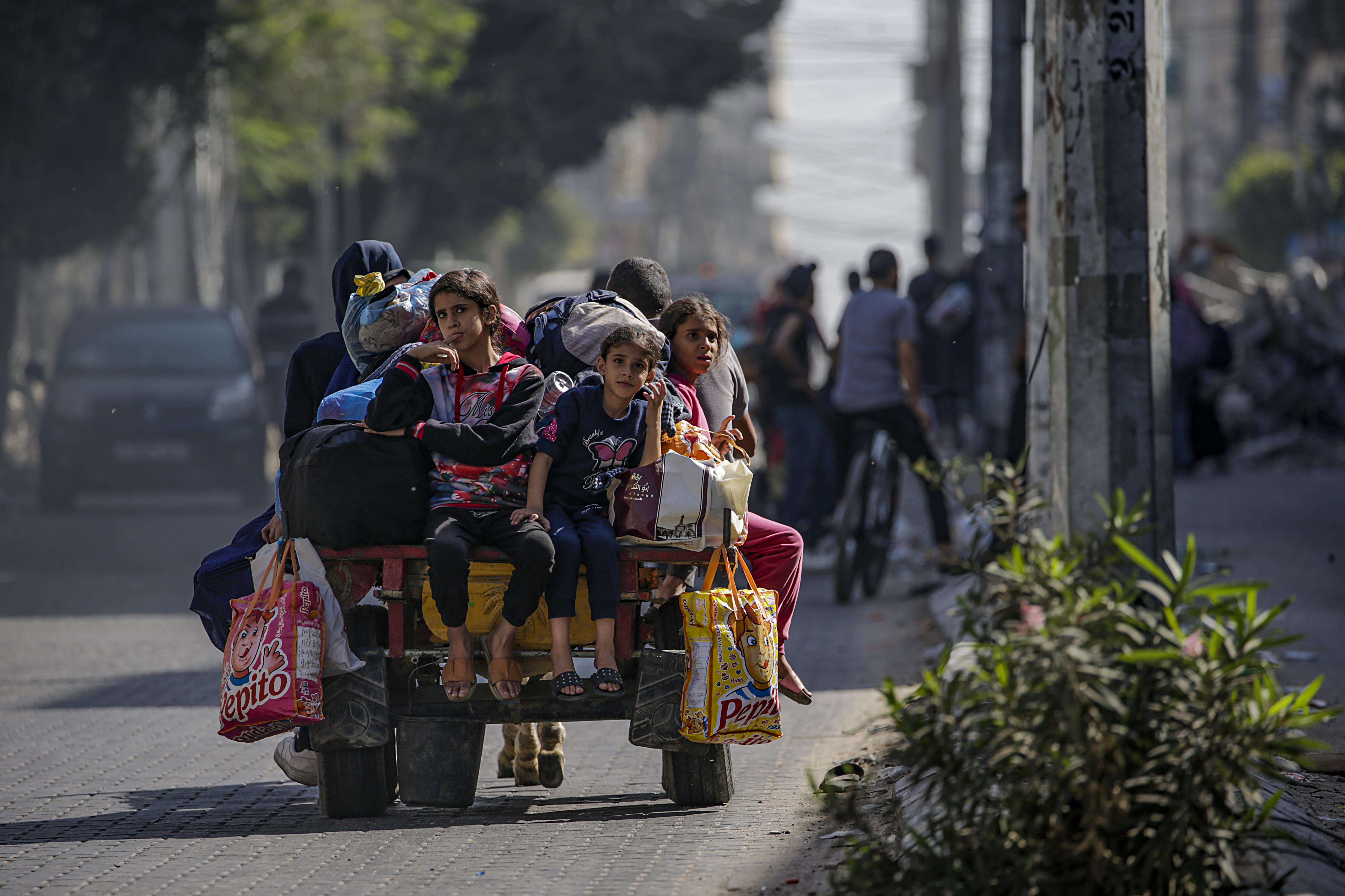 Residents carry their belongings as they evacuate Gaza City amid increased military operations in the Gaza Strip,
