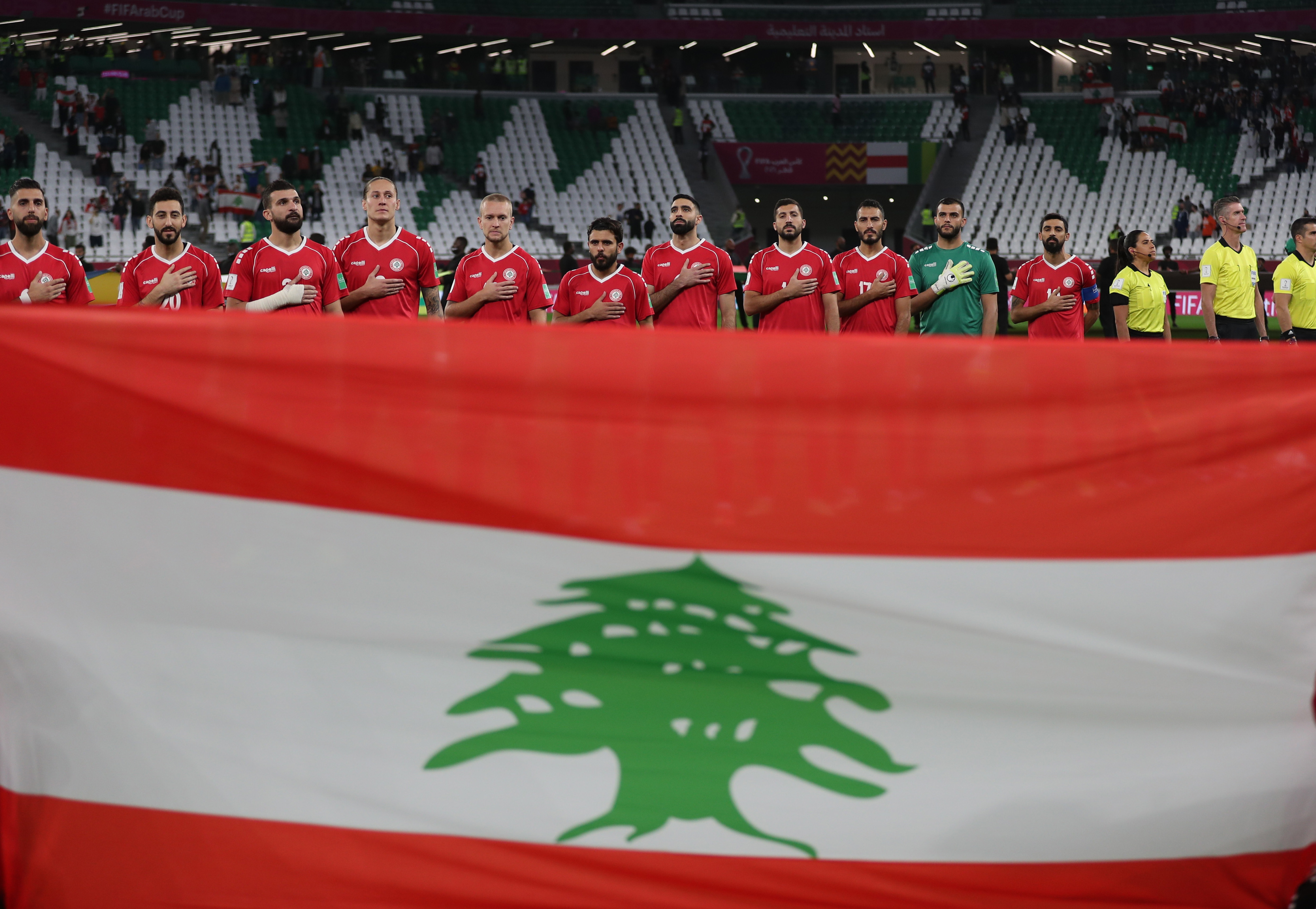 Soccer Football - Arab Cup - Group D - Lebanon v Sudan - Education City Stadium, Al Rayyan, Qatar - December 7, 2021 Lebanon players line up during the national anthems before the match REUTERS/Suhaib Salem
