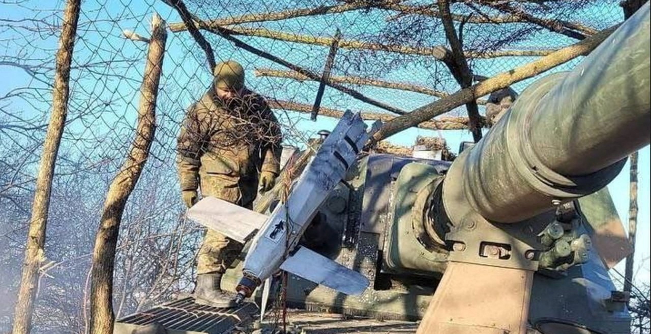 A suspected Russian Lancet drone on military equipment. A soldier is behind.