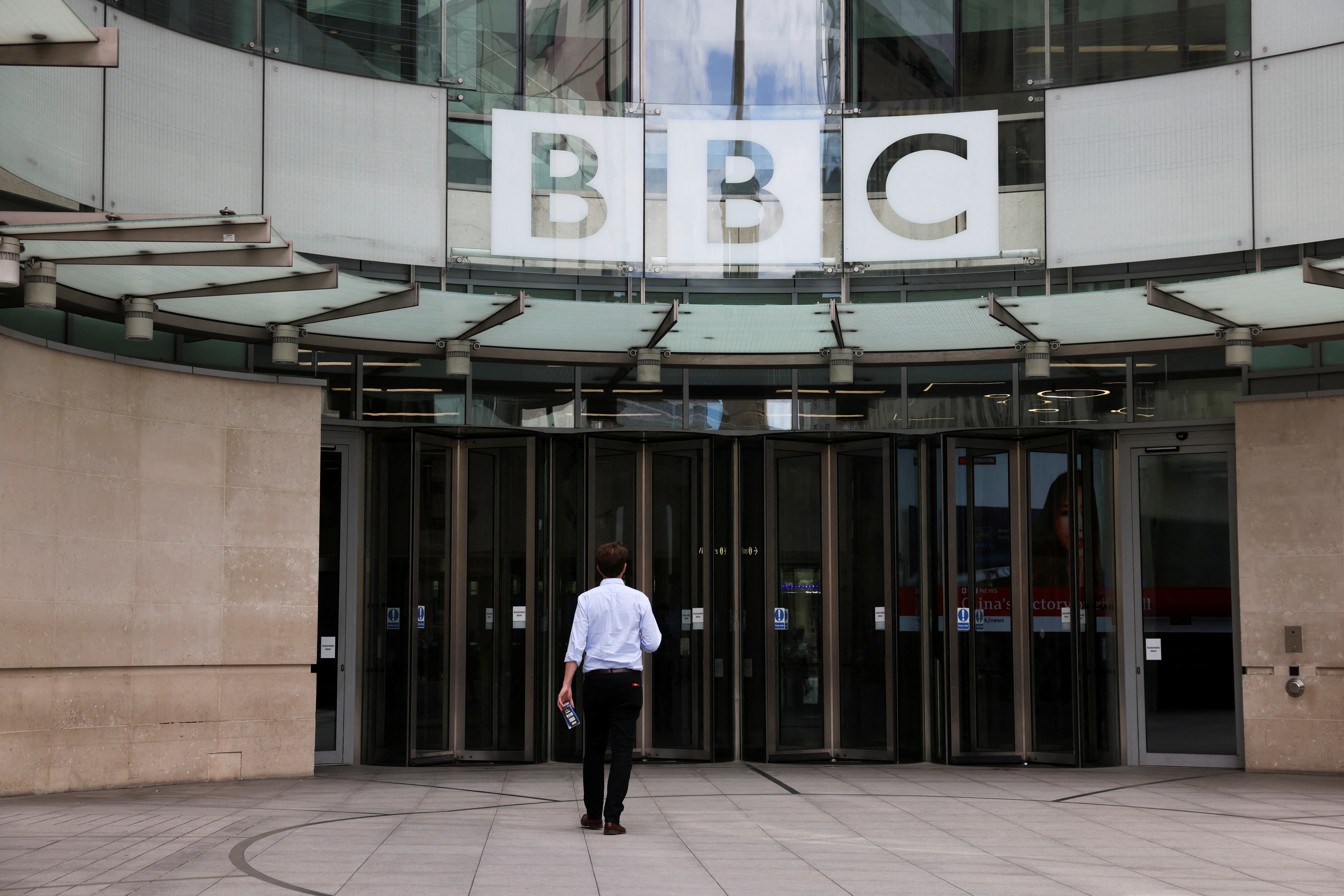 A person walks outside the BBC headquarters in London, Britain, July 10, 2023. REUTERS/Hollie Adams