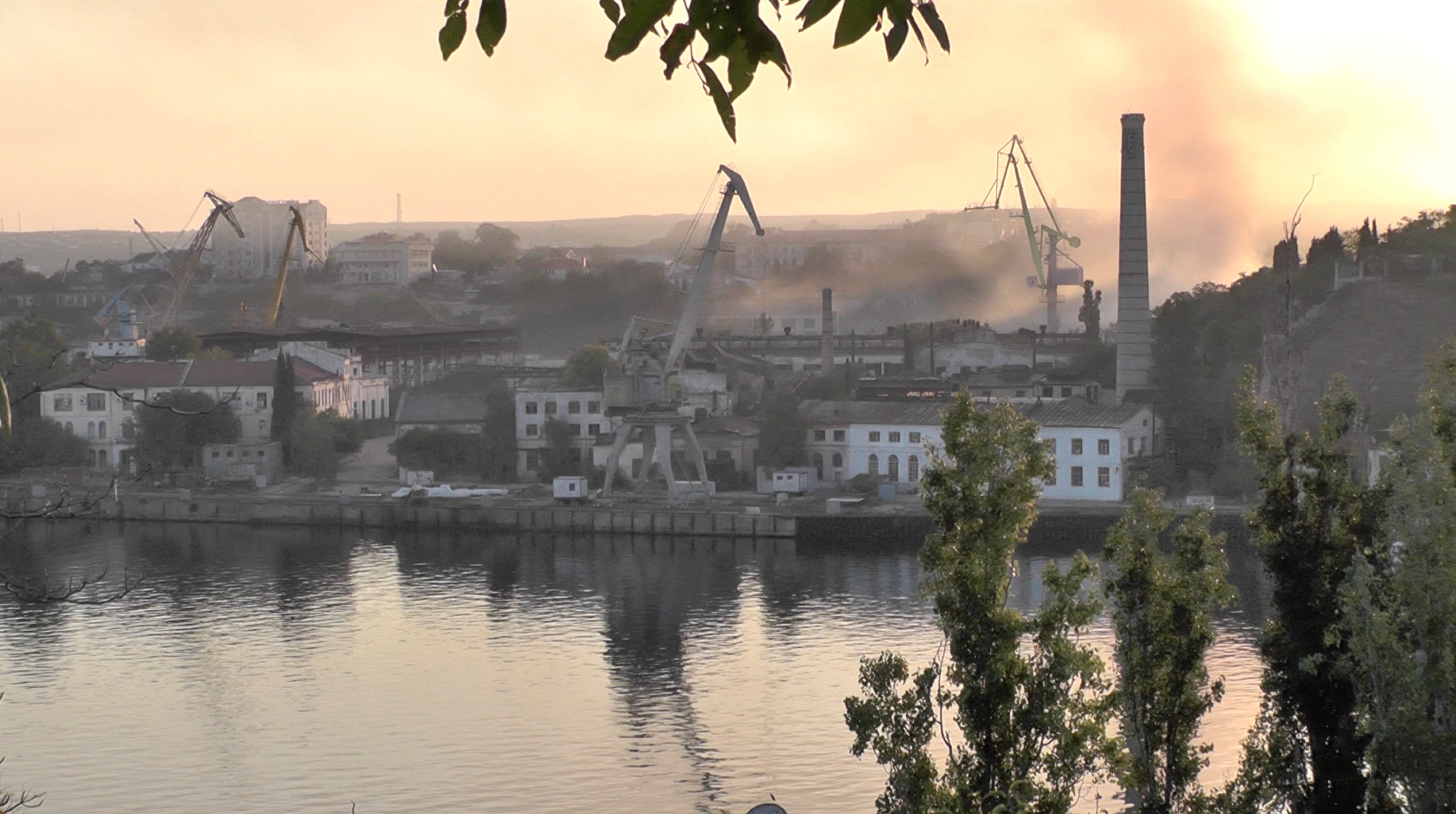Smoke rises from a shipyard that was reportedly hit by a Ukrainian missile attack in Sevastopol, Crimea, in this still image from video taken on September 13, 2023 [Reuters TV via Reuters]