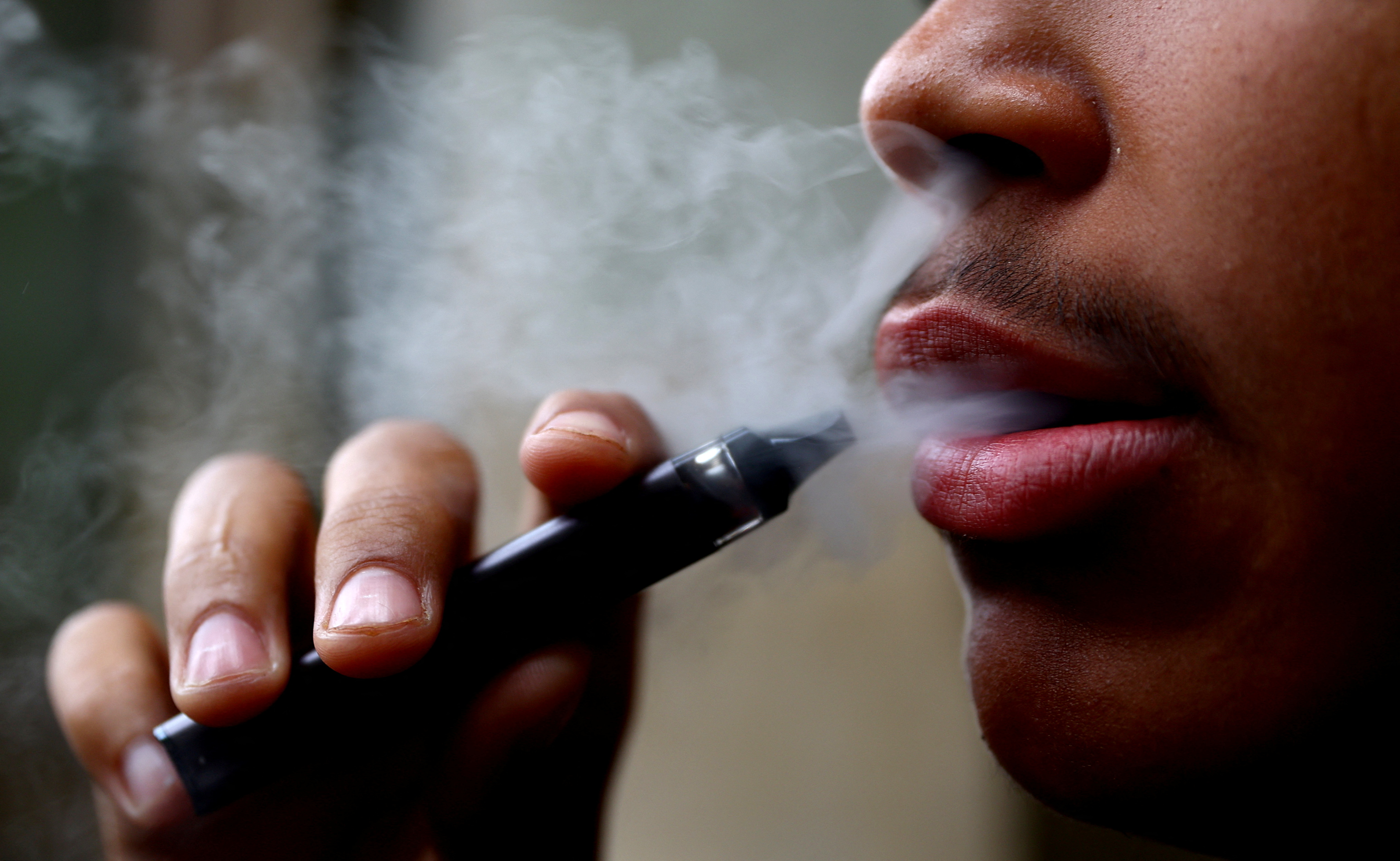 A man smokes a disposable vape, Newcastle-under-Lyme, Britain, September 14, 2023. REUTERS/Carl Recine