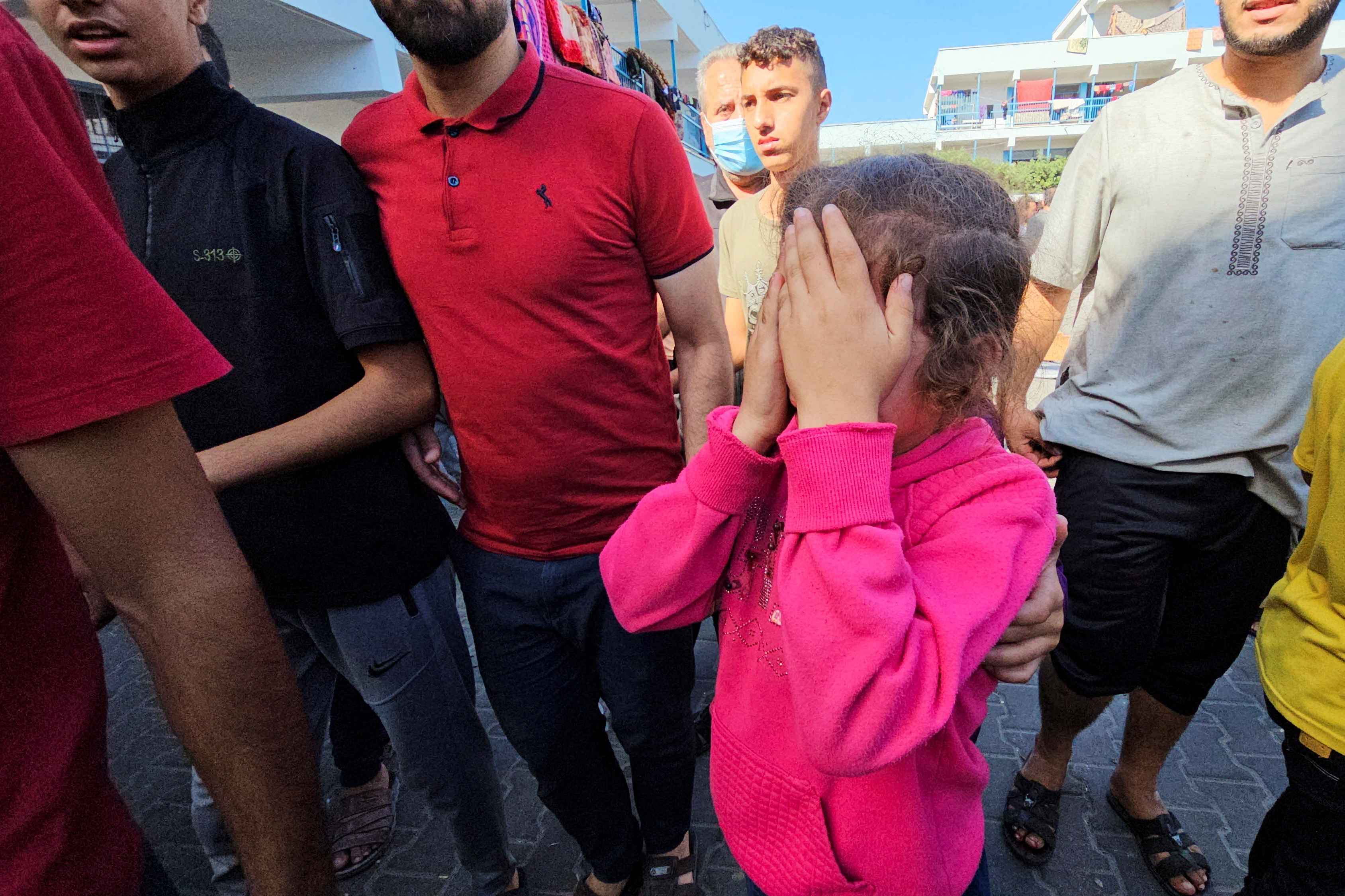 A Palestinian child reacts following a strike at a UN-run school sheltering displaced people, amid the ongoing conflict between Israel and Palestinian Islamist group Hamas, in the Jabalia refugee camp