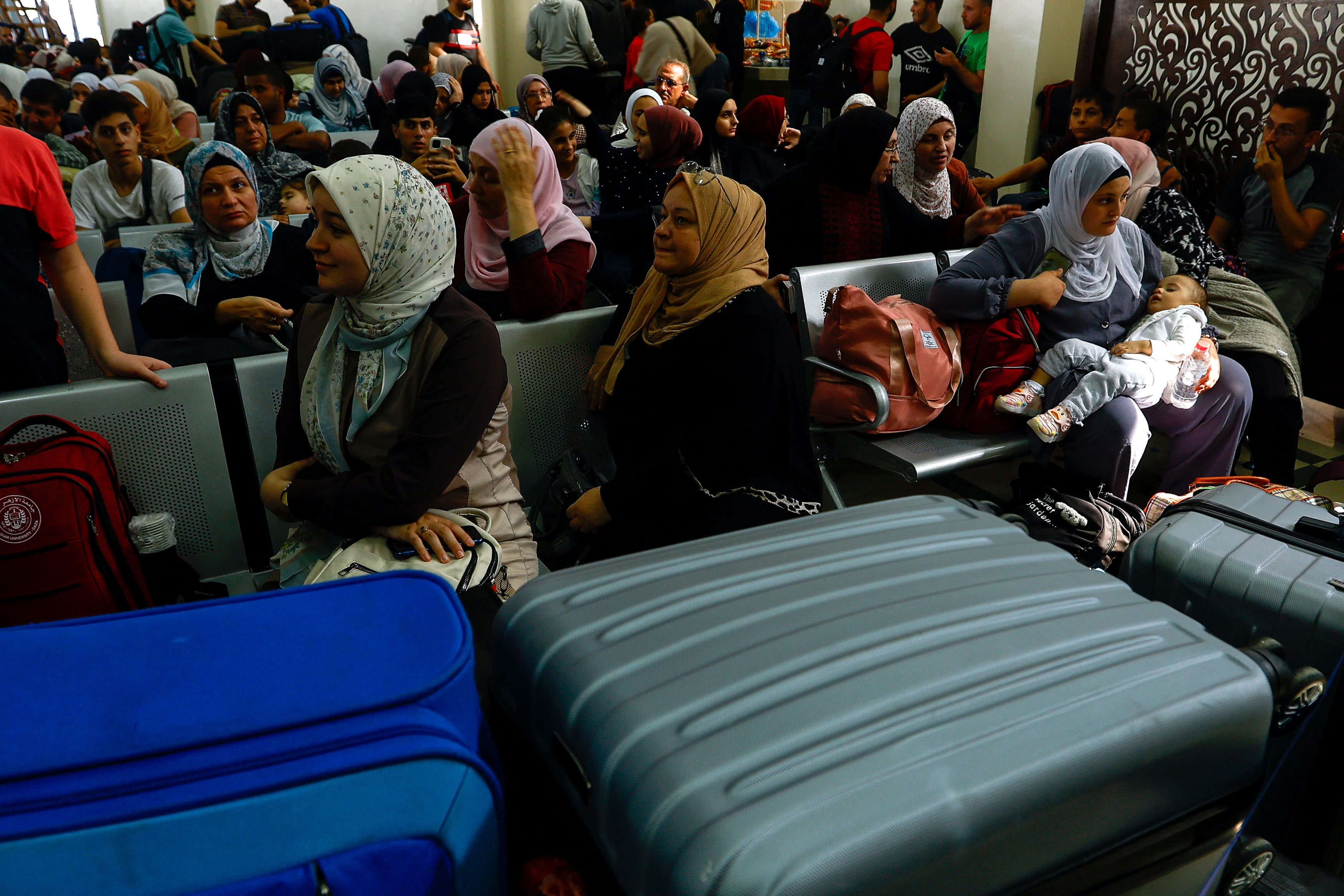 Palestinians with foreign passports wait for permission to leave Gaza