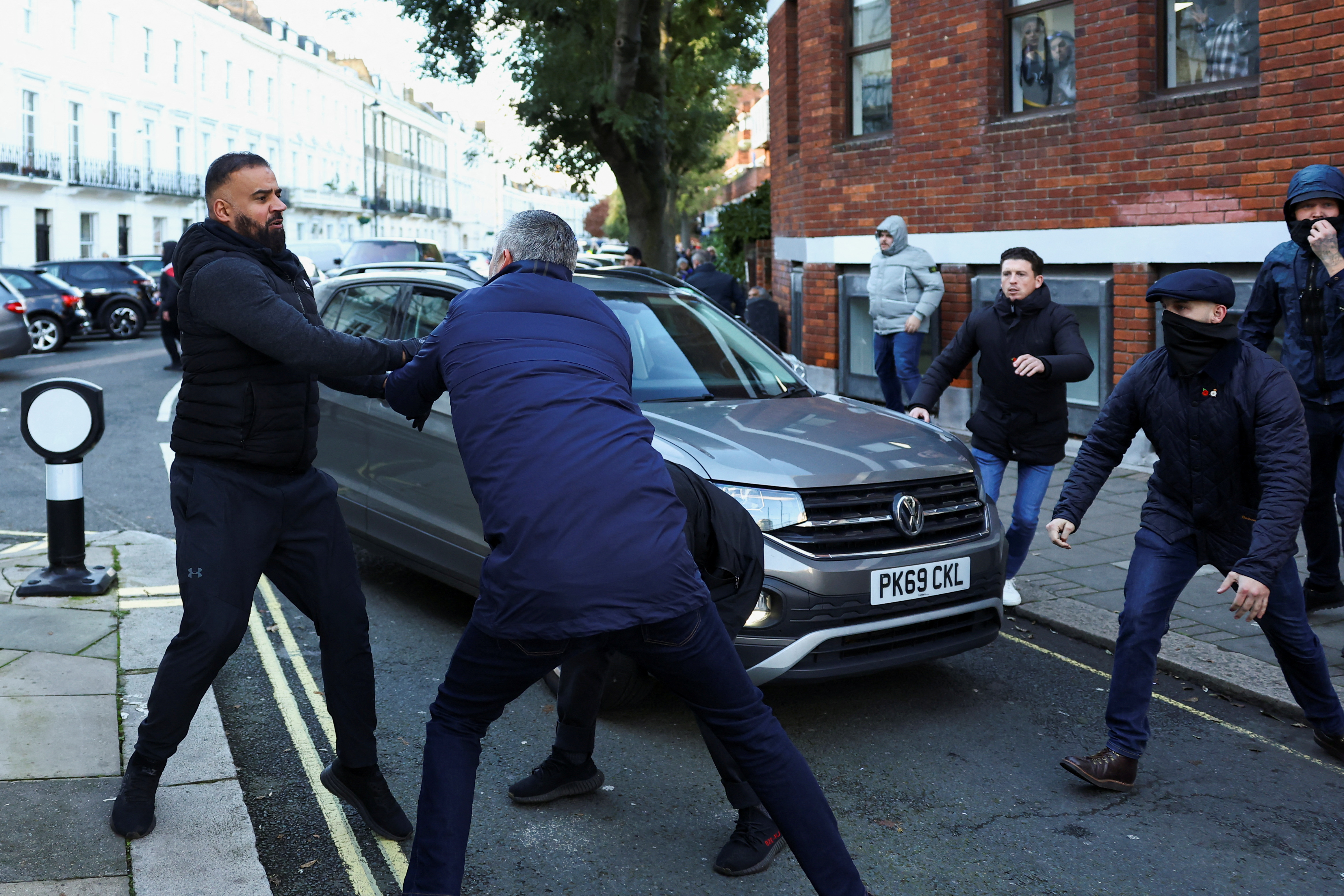 A pro-Palestinian supporter clashes with counter-protesters, on the day of a protest in solidarity with Palestinians in Gaza, amid the ongoing conflict between Israel and the Palestinian Islamist group Hamas, in London