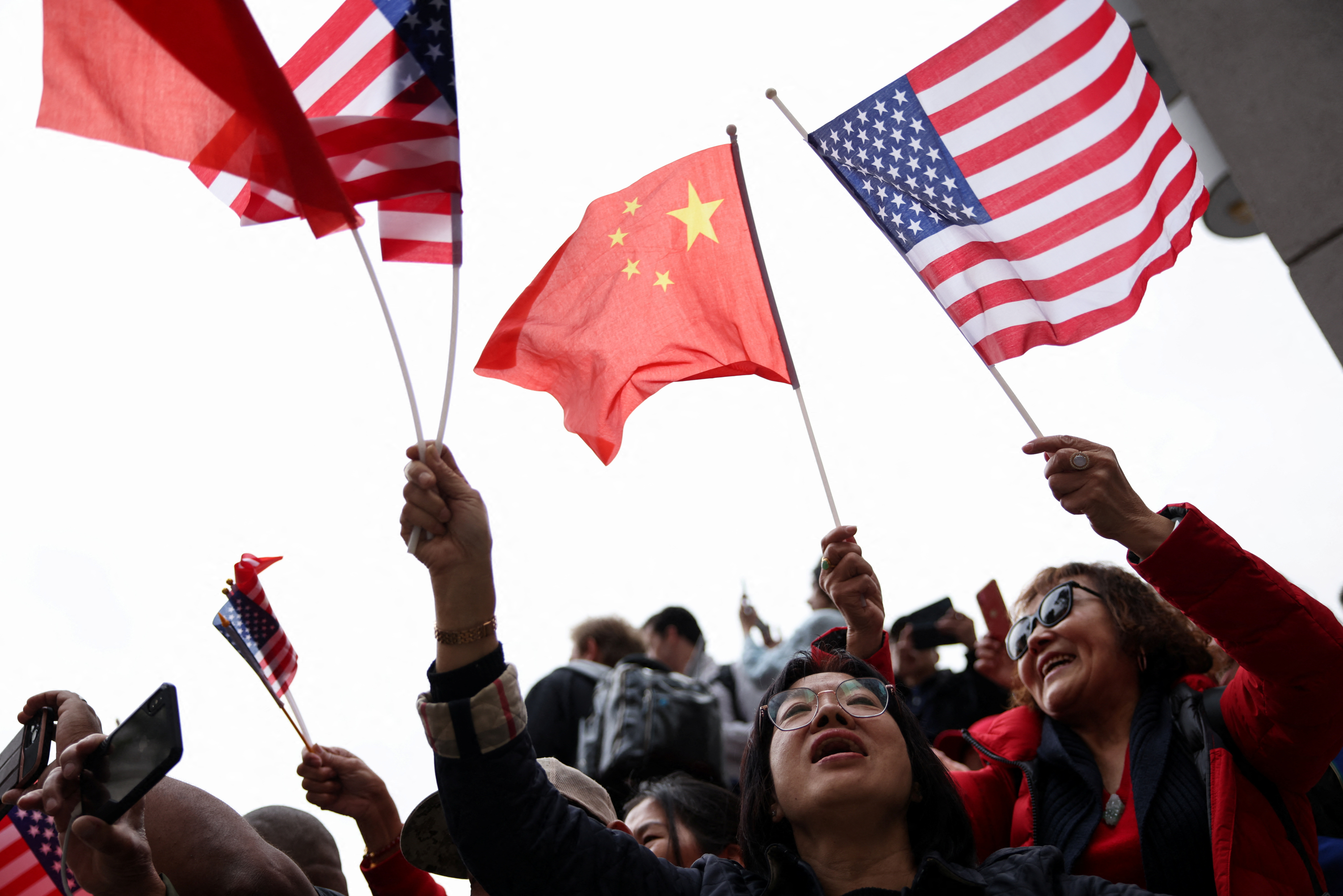 Xi Jinping supporters waving Chinese and US flags outside his hotel.
