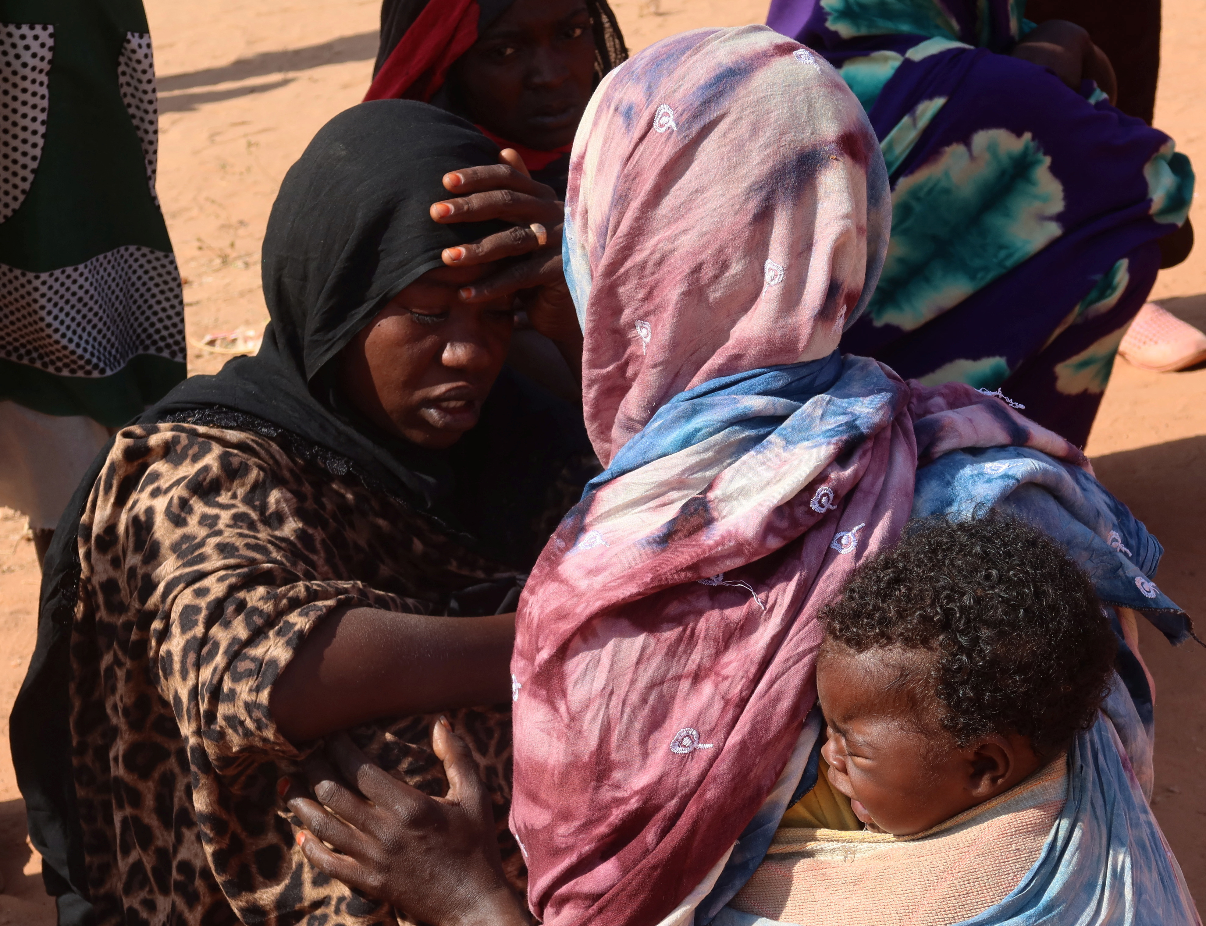 Women from el-Geneina, West Darfur, await news of their missing relatives as they gather near the border crossing in Adre, Chad, November 7, 2023