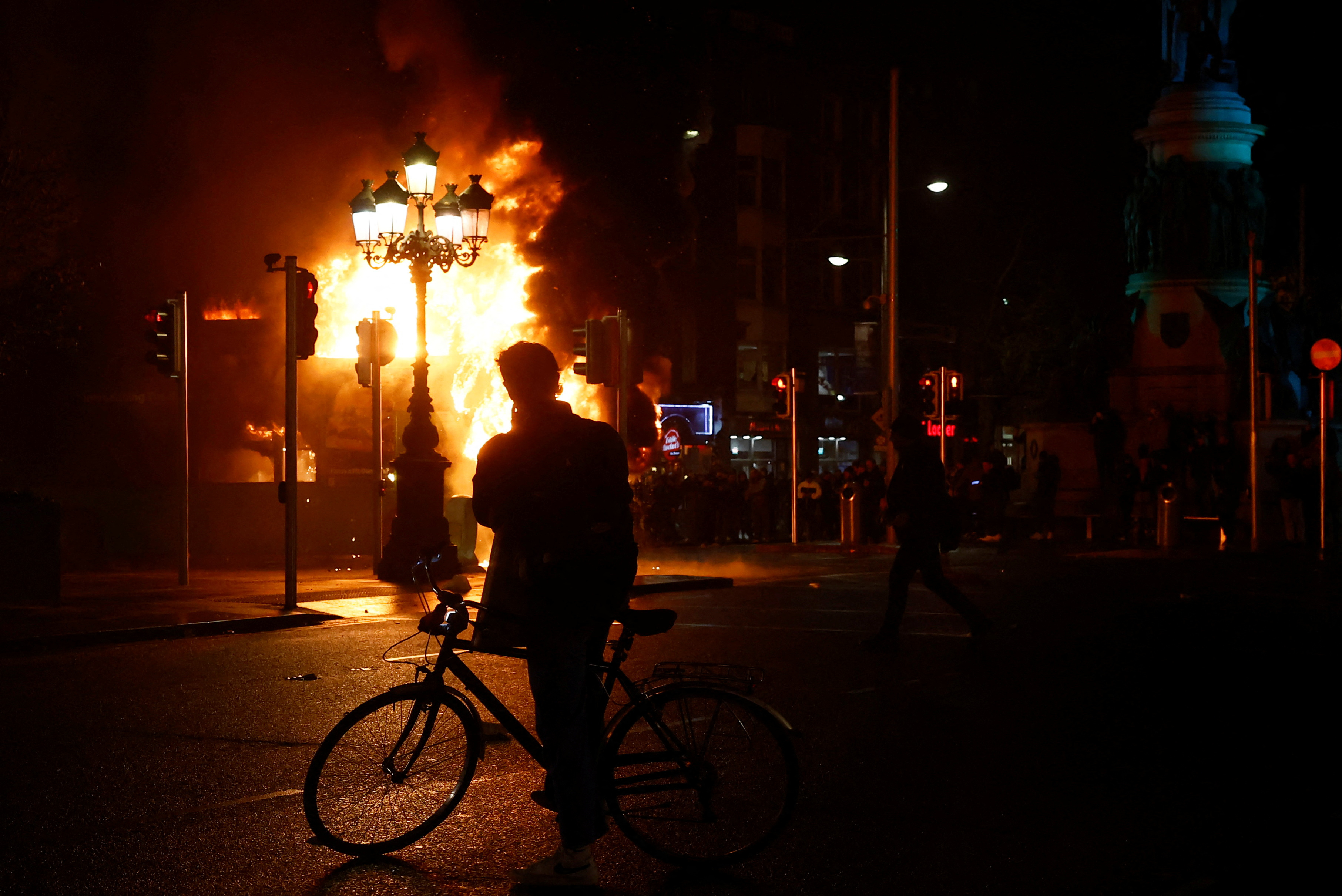 A bus burns during a demonstration following a suspected stabbing that left few children injured in Dublin