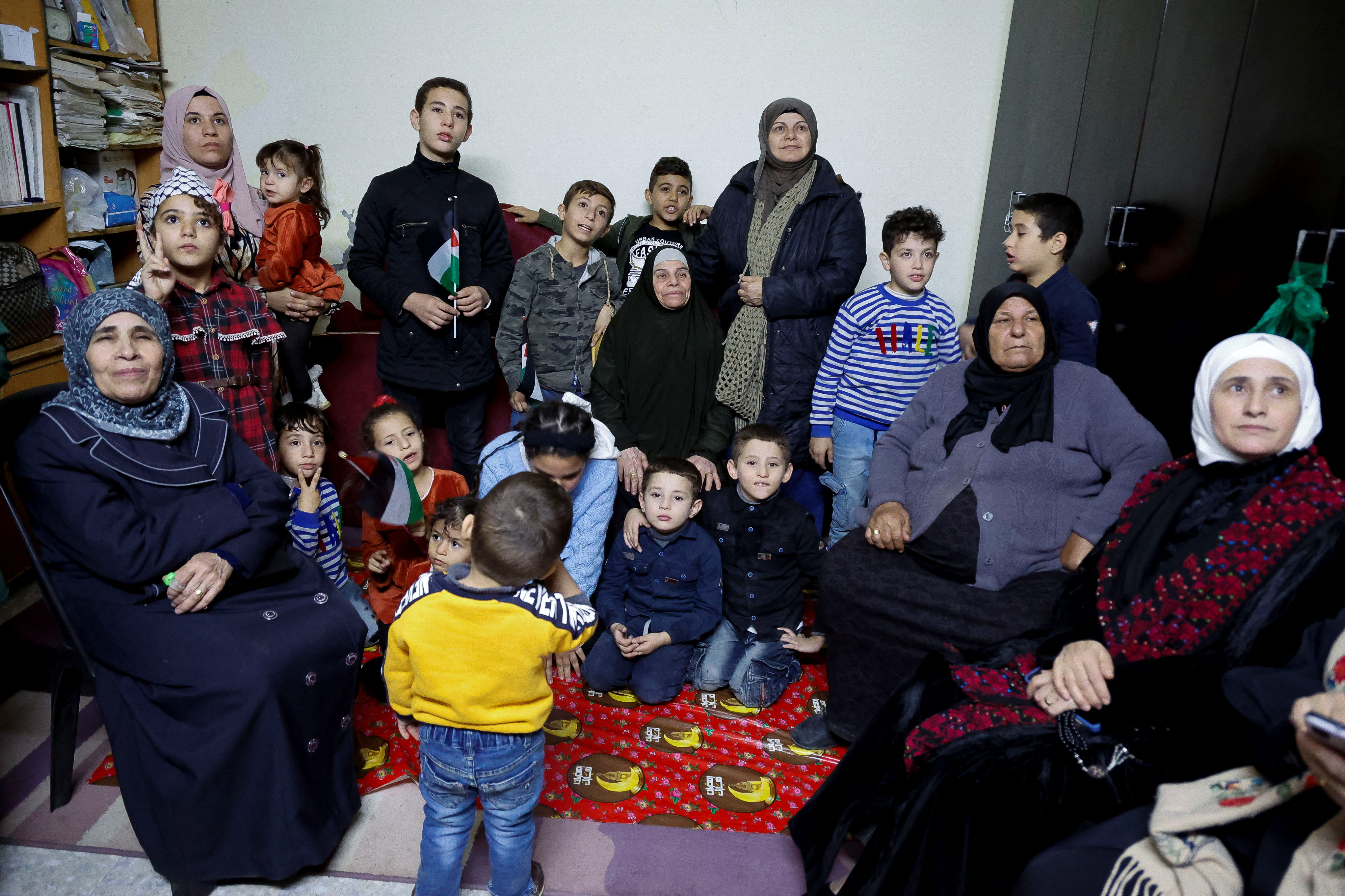 Family of released Palestinian prisoner Fatima Amarneh wait at home while watching television, after hostages-prisoners swap deal between Hamas and Israel, near Jenin in the Israeli-occupied West Bank November 24