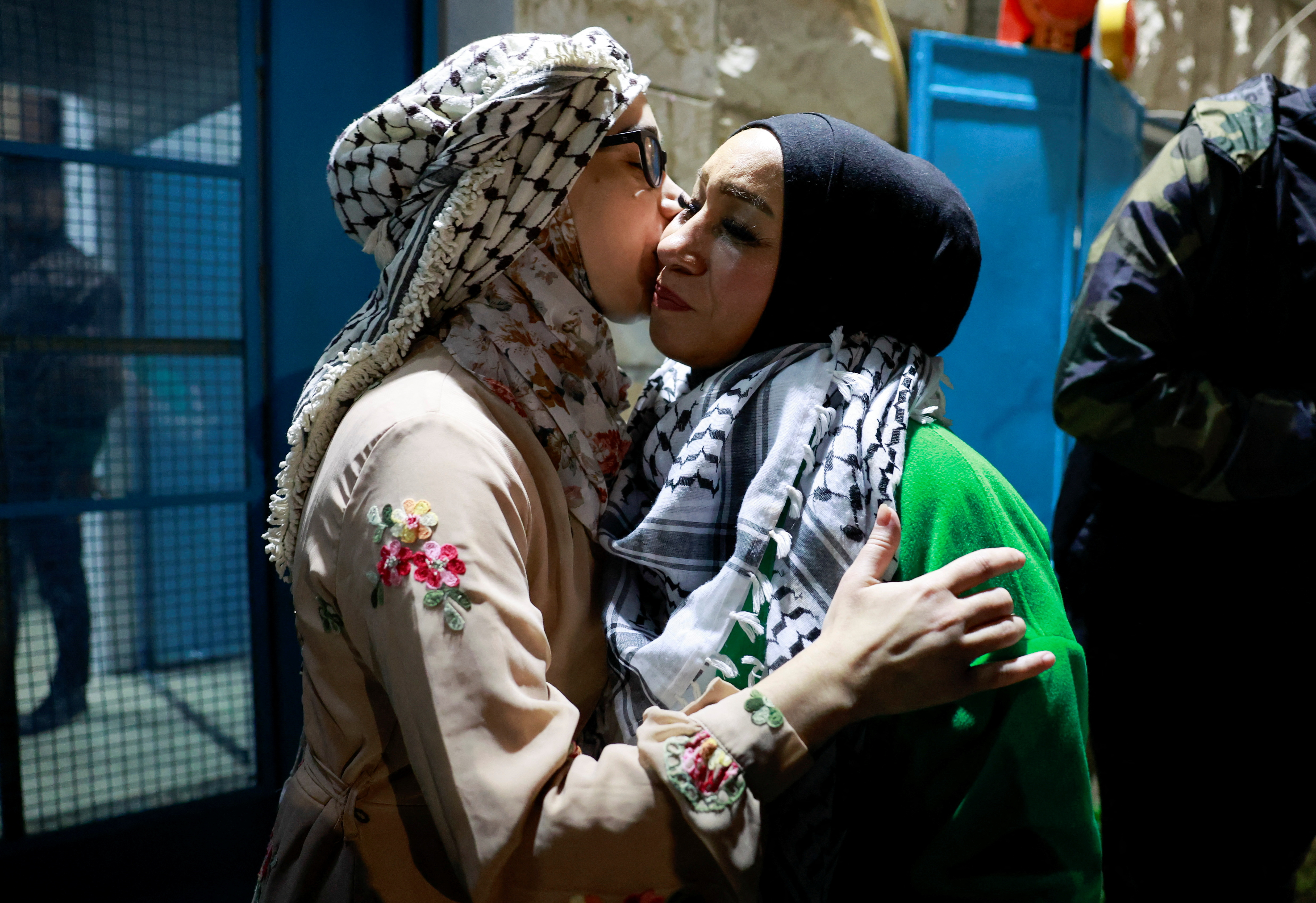 A released Palestinian prisoner kisses a loved one as she leaves the Israeli military prison, Ofer, after hostages-prisoners swap deal between Hamas and Israel near Ramallah in the Israeli-occupied West Bank November 24