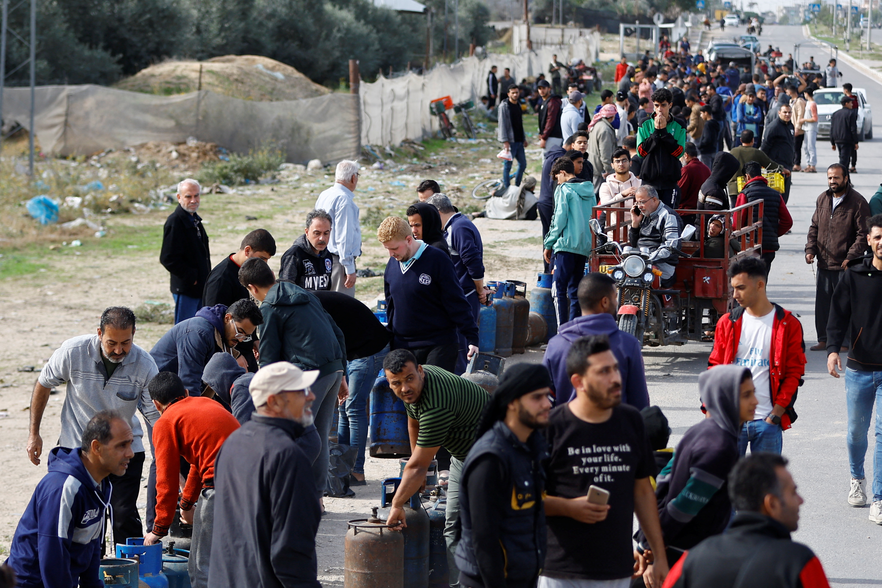 Palestinians gather to buy fuel, amid fuel shortages, during a temporary truce between Hamas and Israel, in Rafah in the southern Gaza Strip November 25