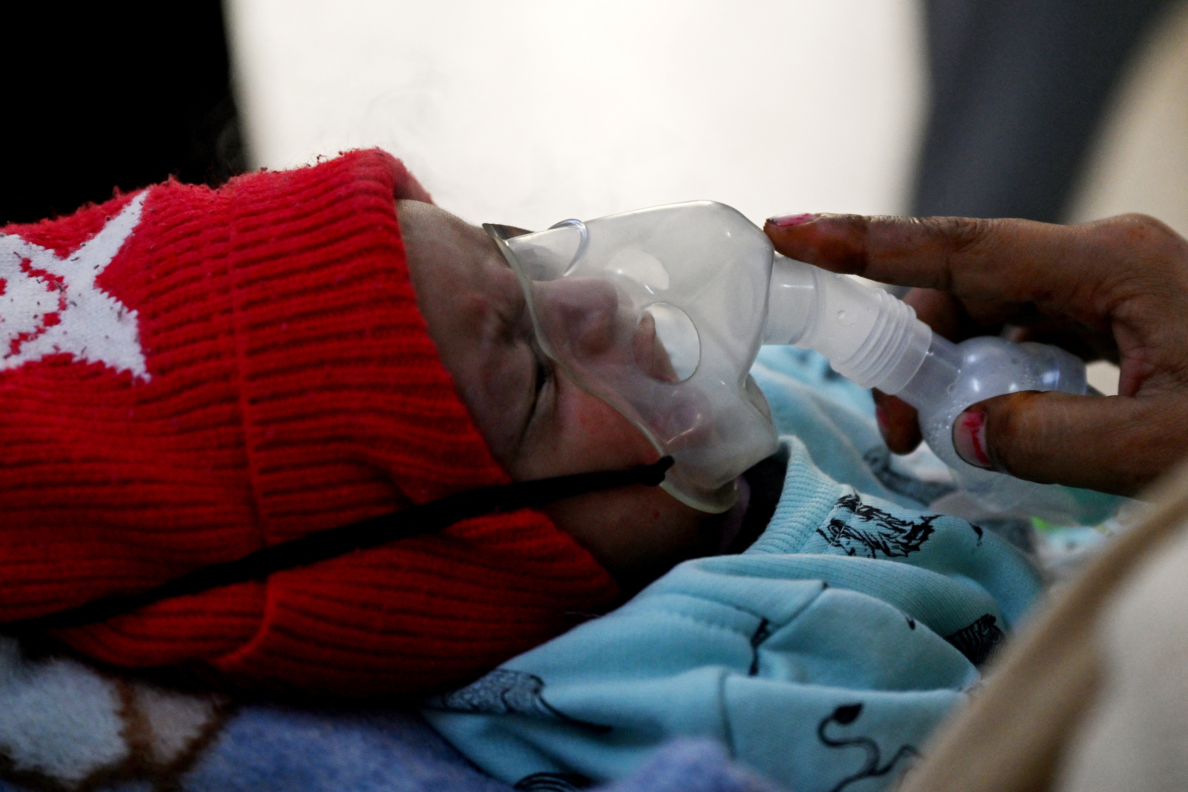 In this picture taken on November 7, 2023, a one-month-old baby breathes with the help of a nebuliser at the emergency ward of the government-run Chacha Nehru Bal Chikitsalaya children hospital in New Delhi.