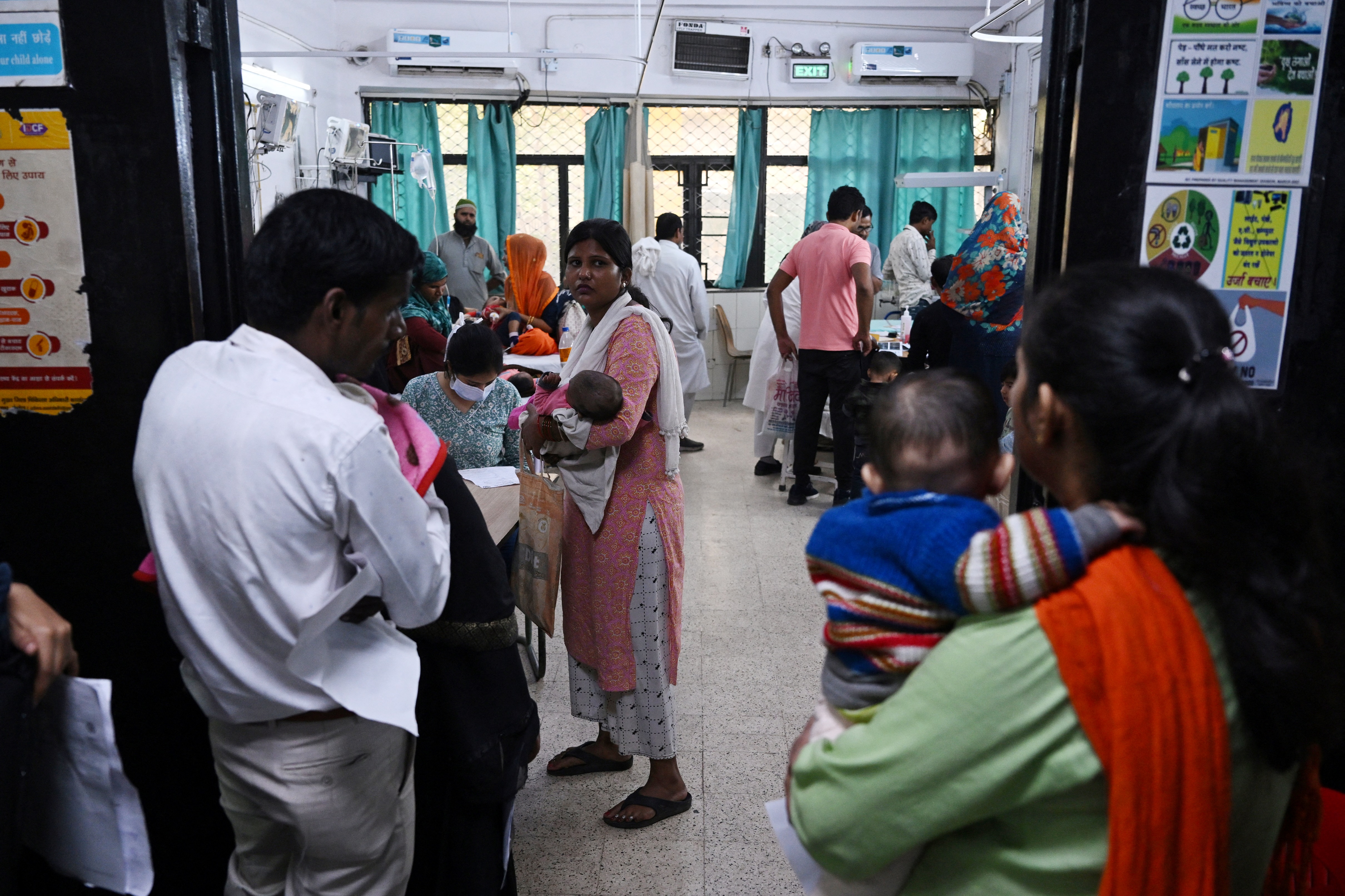 In this picture taken on November 7, 2023, relatives with children with breathing difficulties wait to receive treatment outside the emergency ward of the government-run Chacha Nehru Bal Chikitsalaya children hospital in New Delhi.