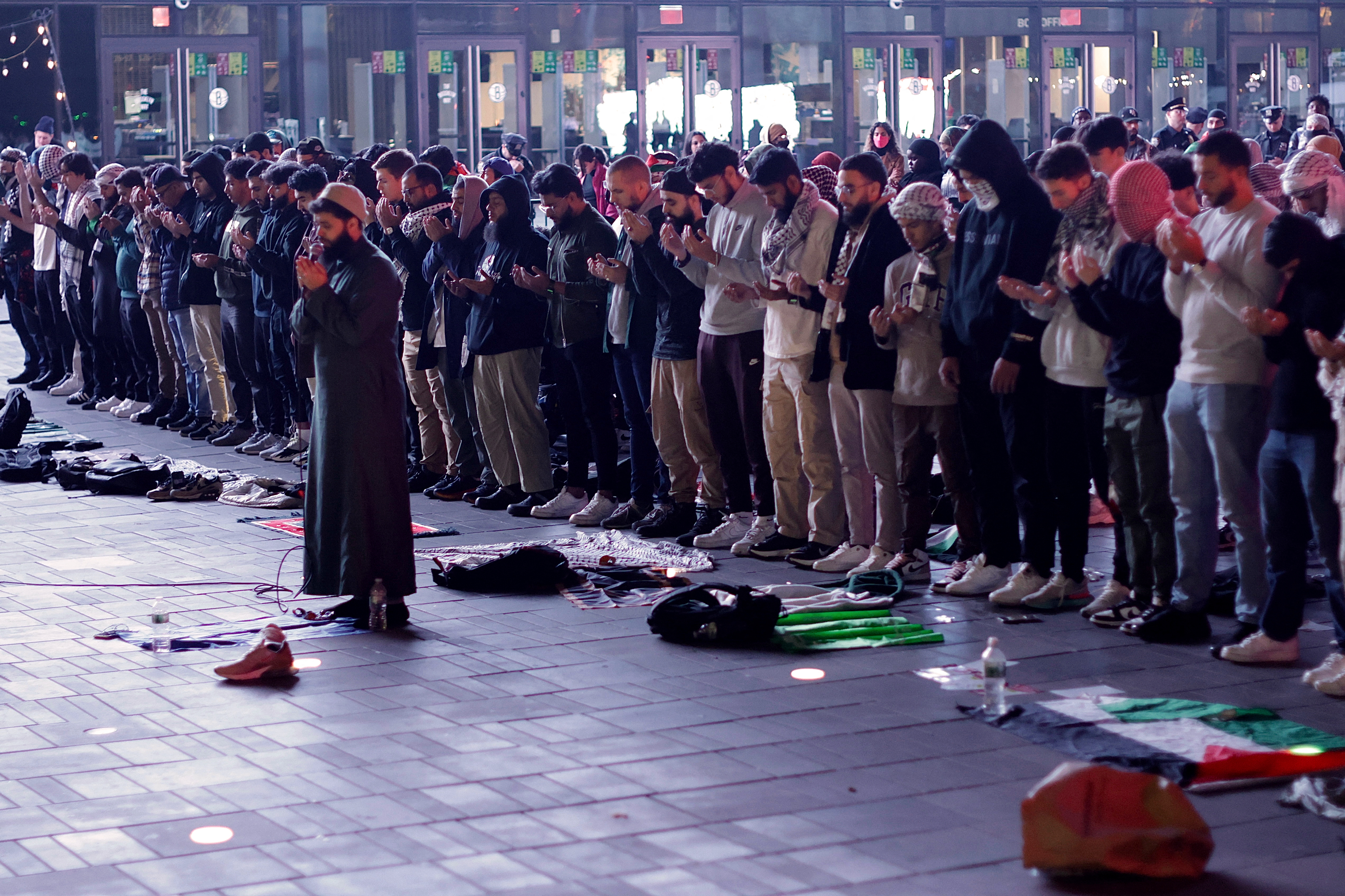 Men pray during a rally in support of Palestinians outside Barclays Center in Brooklyn, New York.