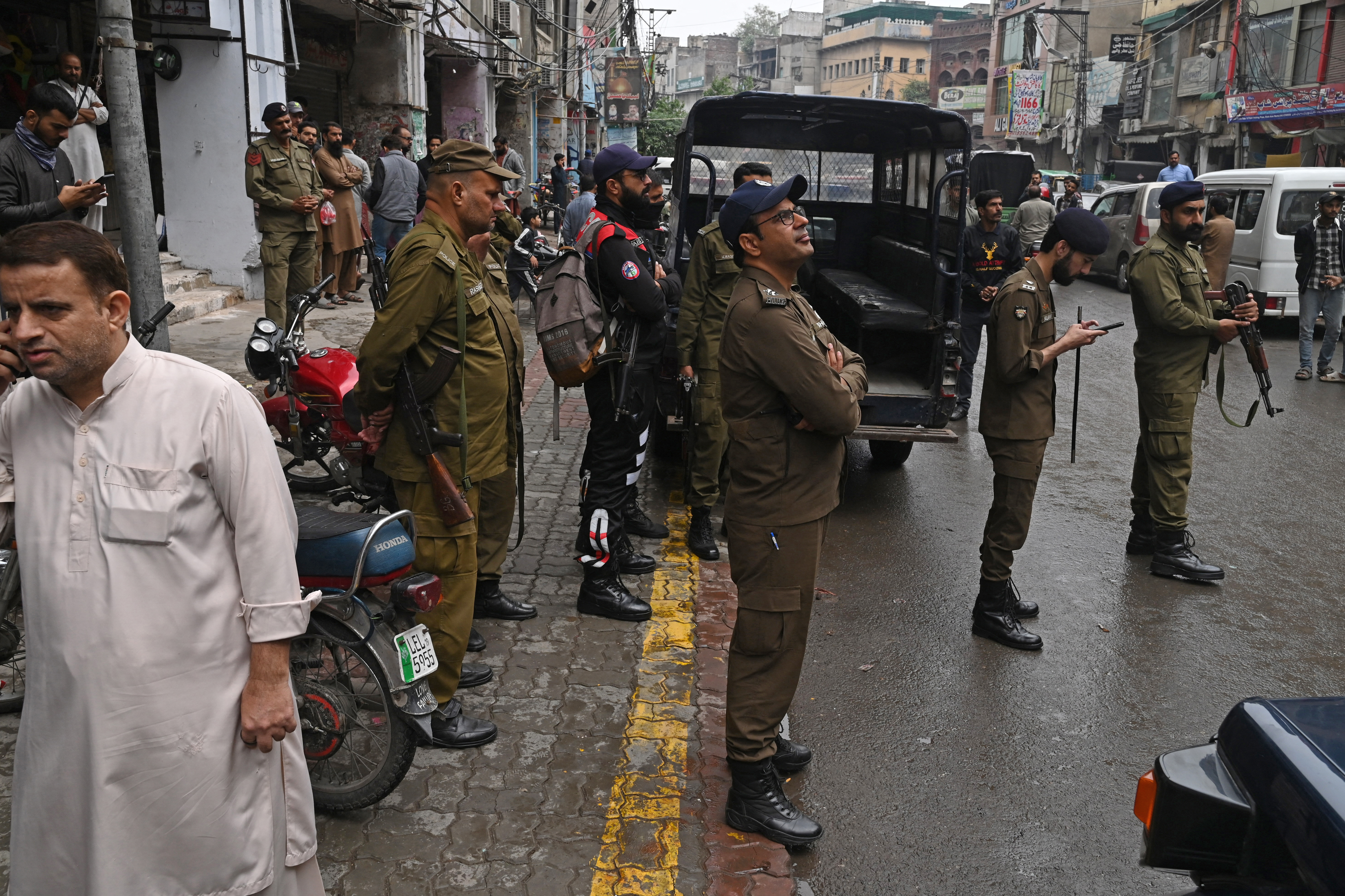 Police personnel patrol a market in Lahore - Smog