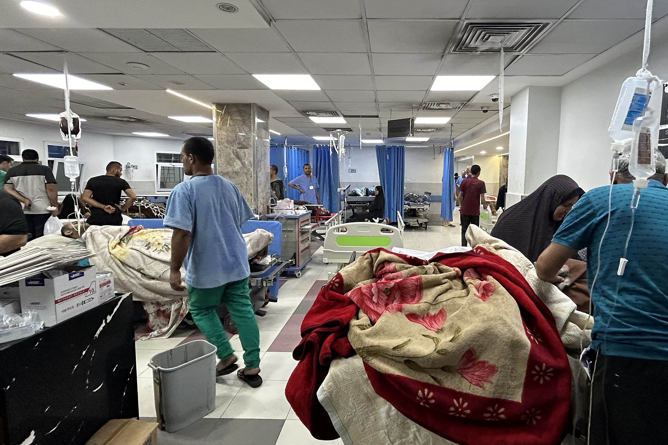 Patients and medics are pictured at Al-Shifa hosp