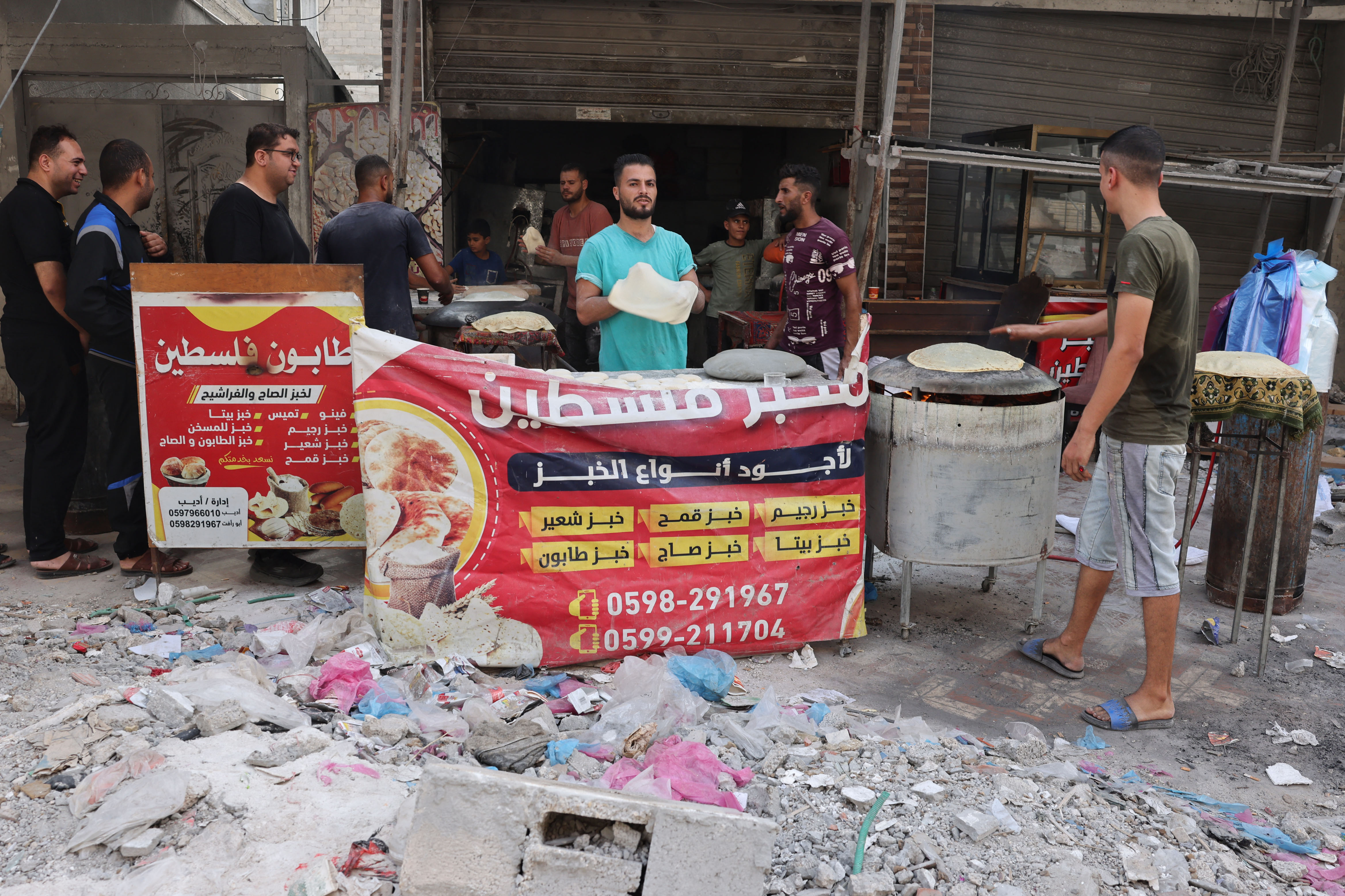 Palestinians make bread amid debris of destroyed buildings in Rafah