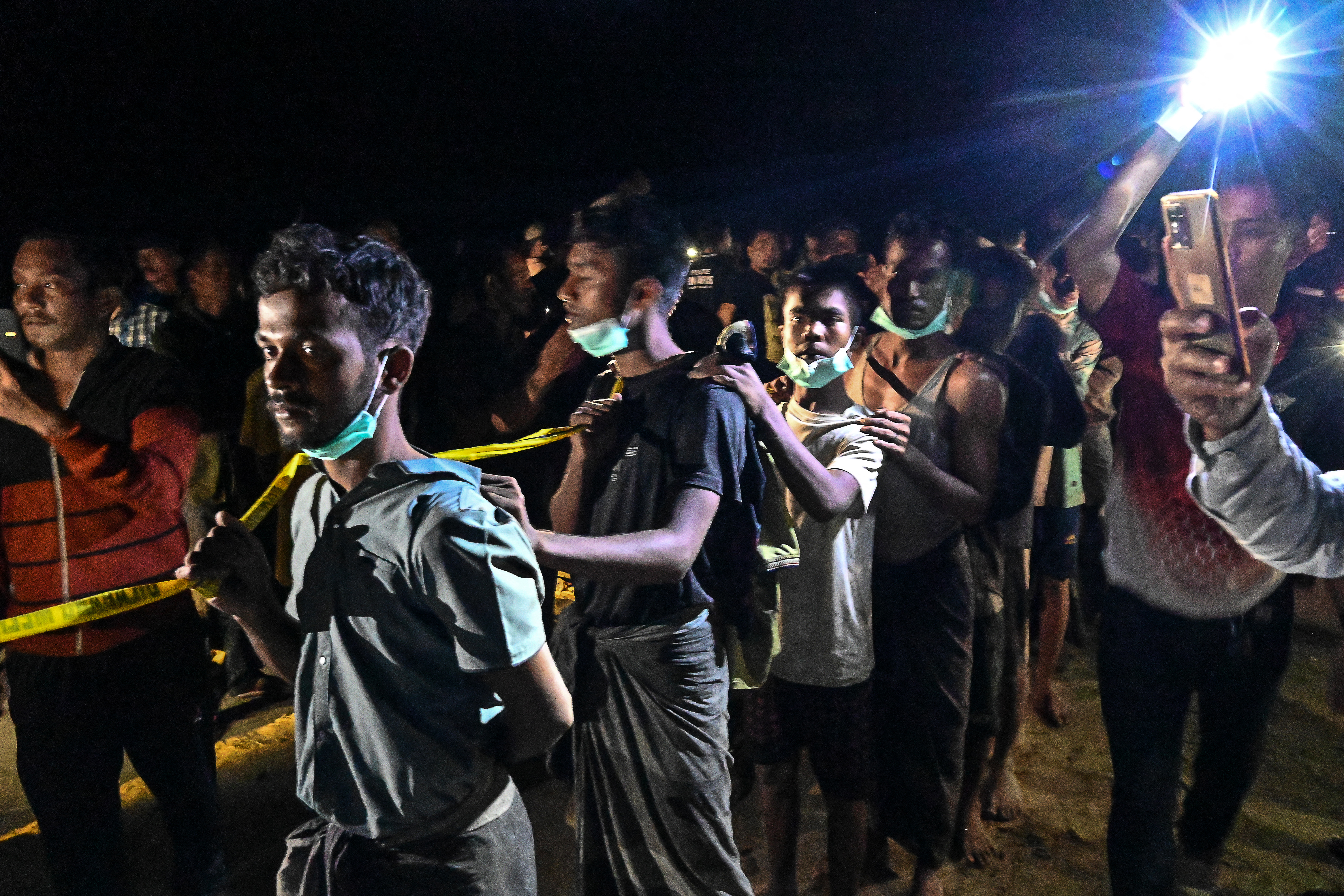 Newly-arrived Rohingya refugees move to be transferred to a shelter in Batee beach, Aceh province, Indonesia.