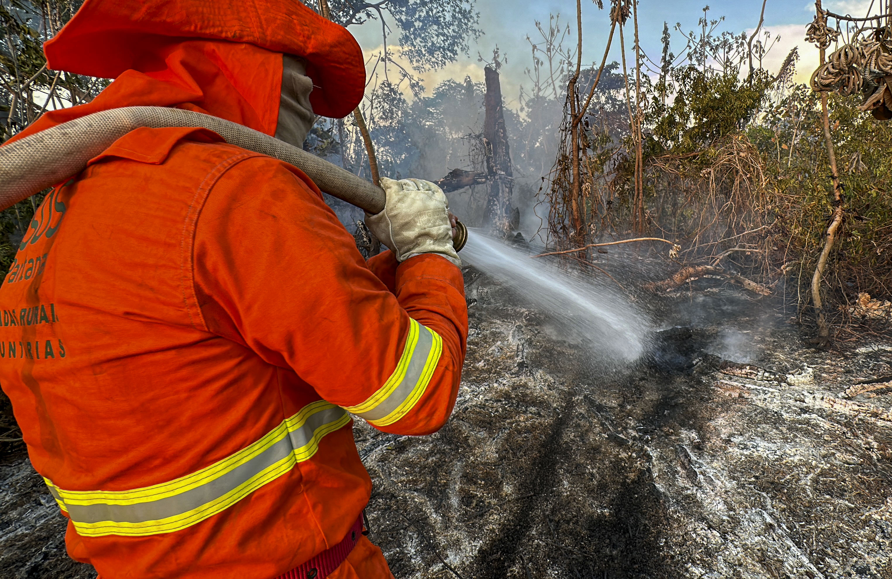 A firefighter extinguishes a fire in the Pantanal wetland in Porto Jofre, Mato Grosso State, Brazil.