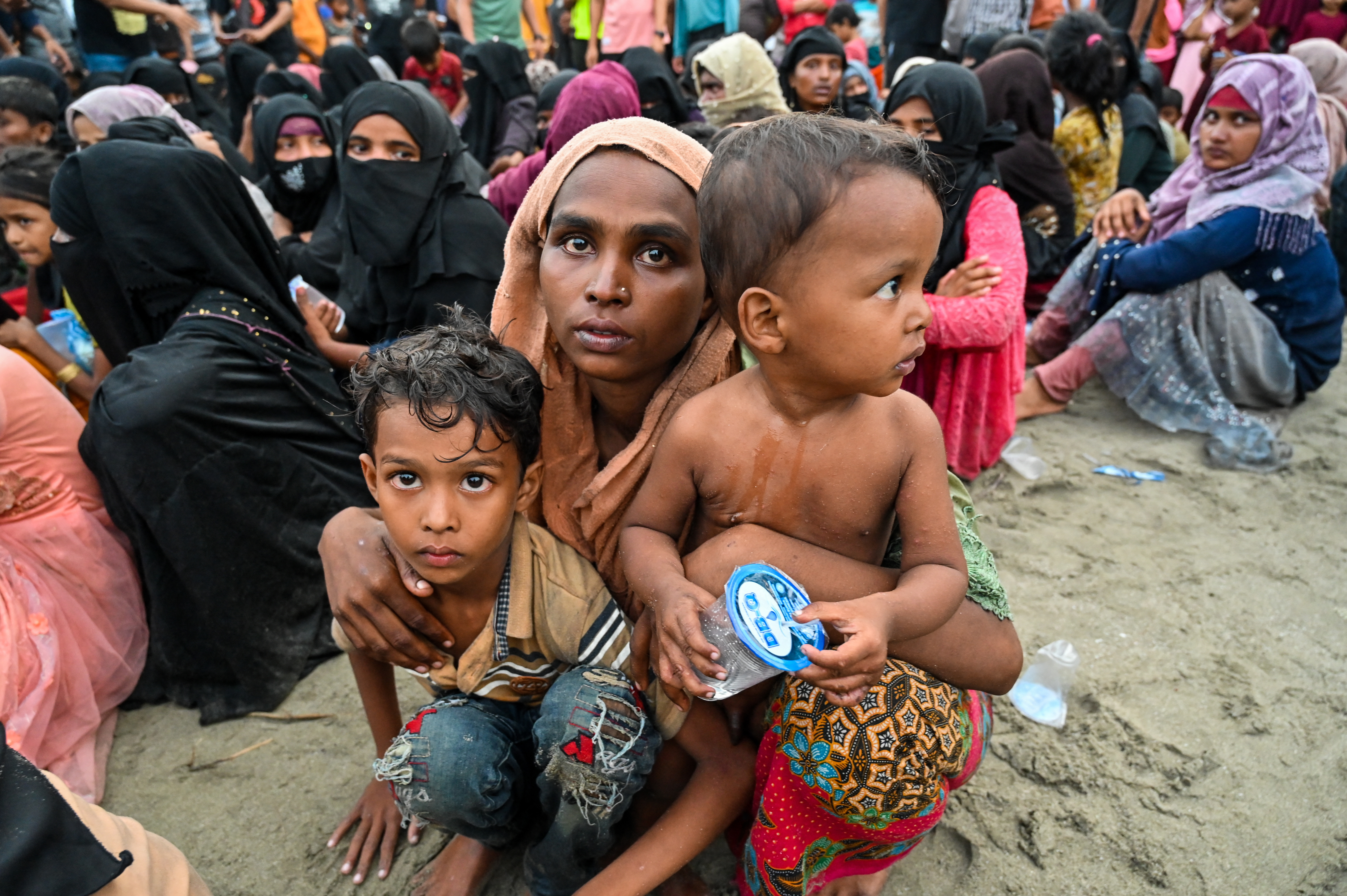 Newly-arrived Rohingya refugees wait to be transferred to a shelter in Batee beach, Aceh province, Indonesia.