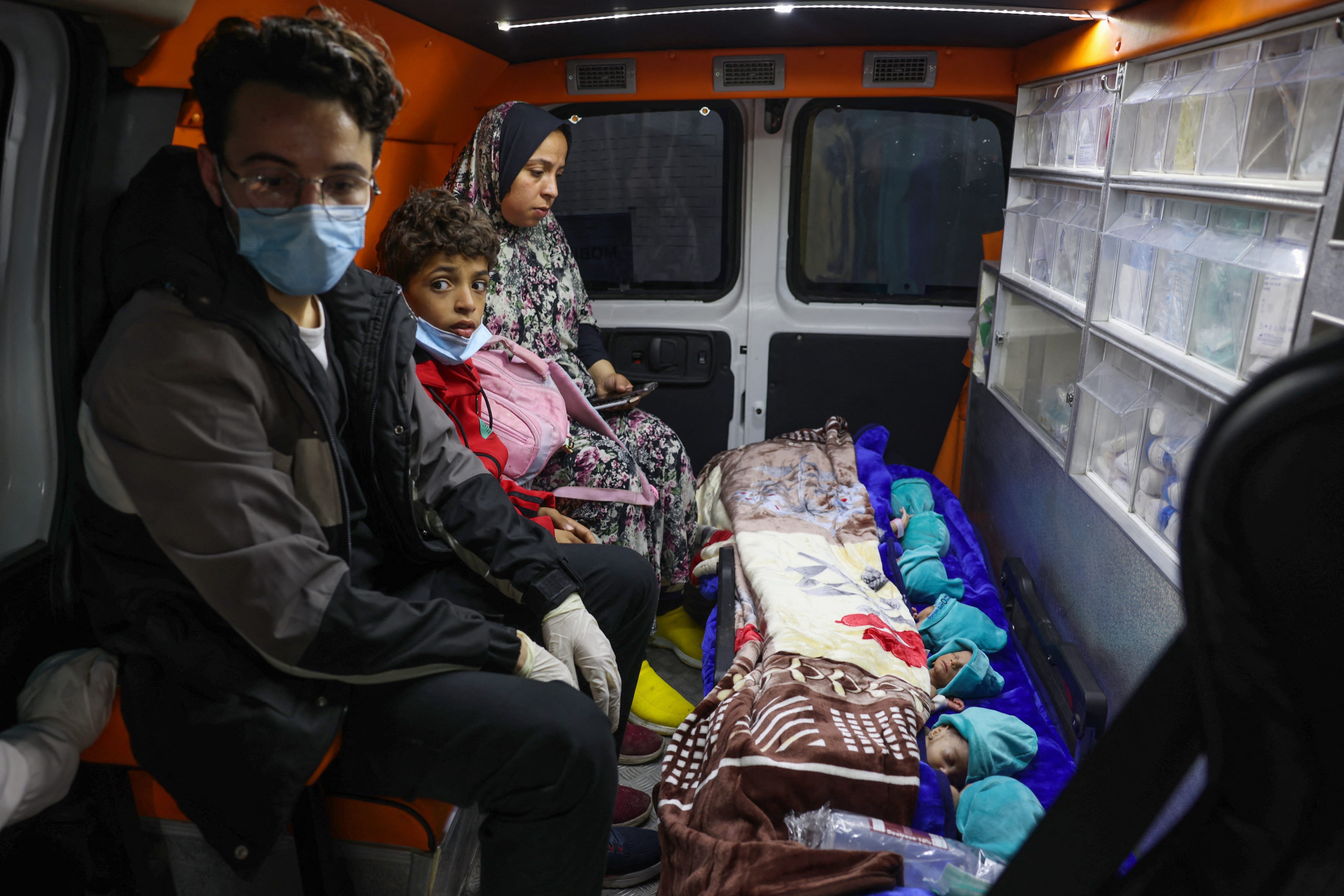 Premature babies, who were evacuated from Al Shifa hospital, lie in an ambulance before they are transported for treatment in UAE, at Rafah border crossing with Egypt