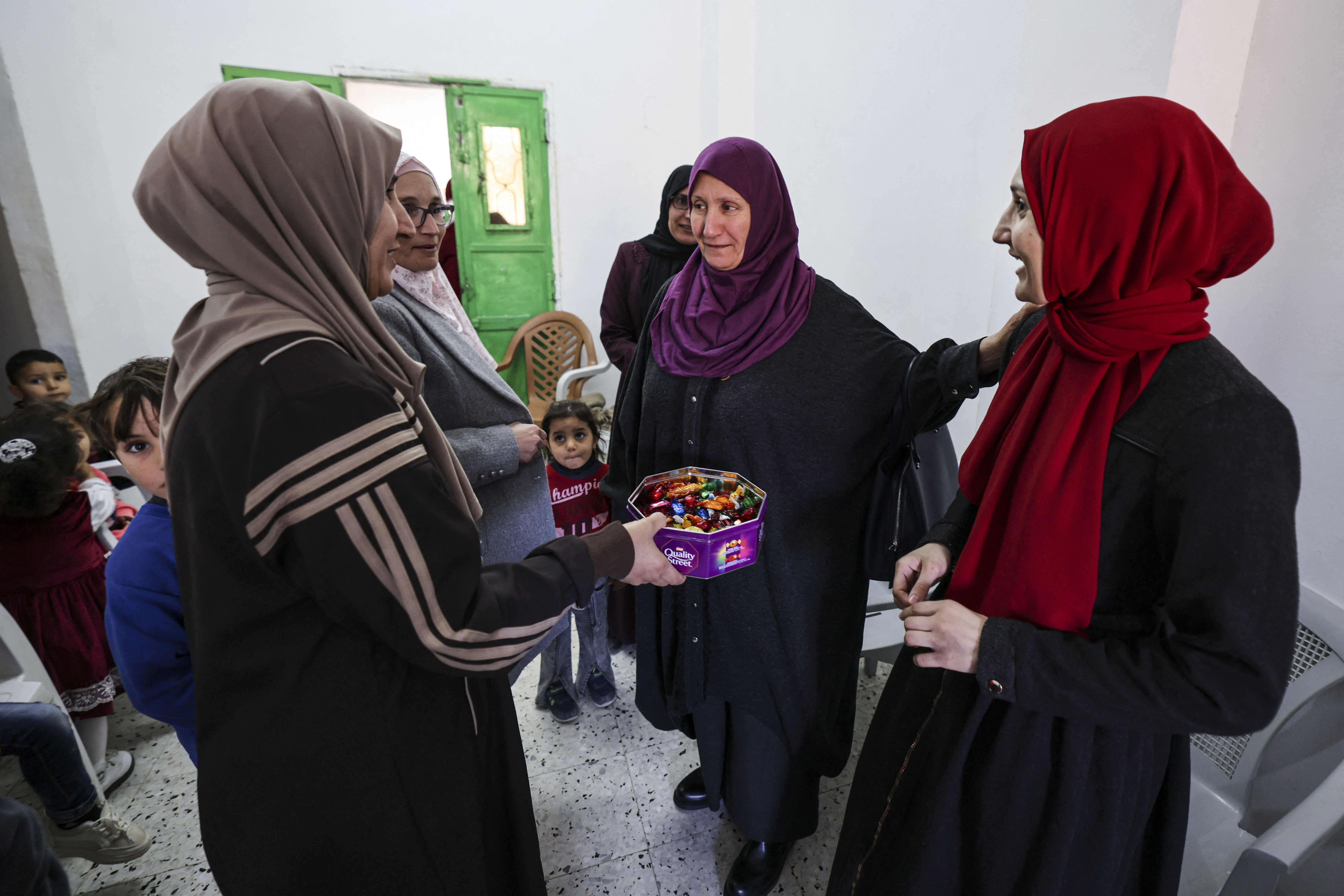 Palestinian former prisoner Maysoon al-Jabali (R), who was jailed in Israel since 2015, greets her family and relatives upon her arrival at her home in Al-Shawawreh village near the occupied West Bank city of Bethlehem on November 26