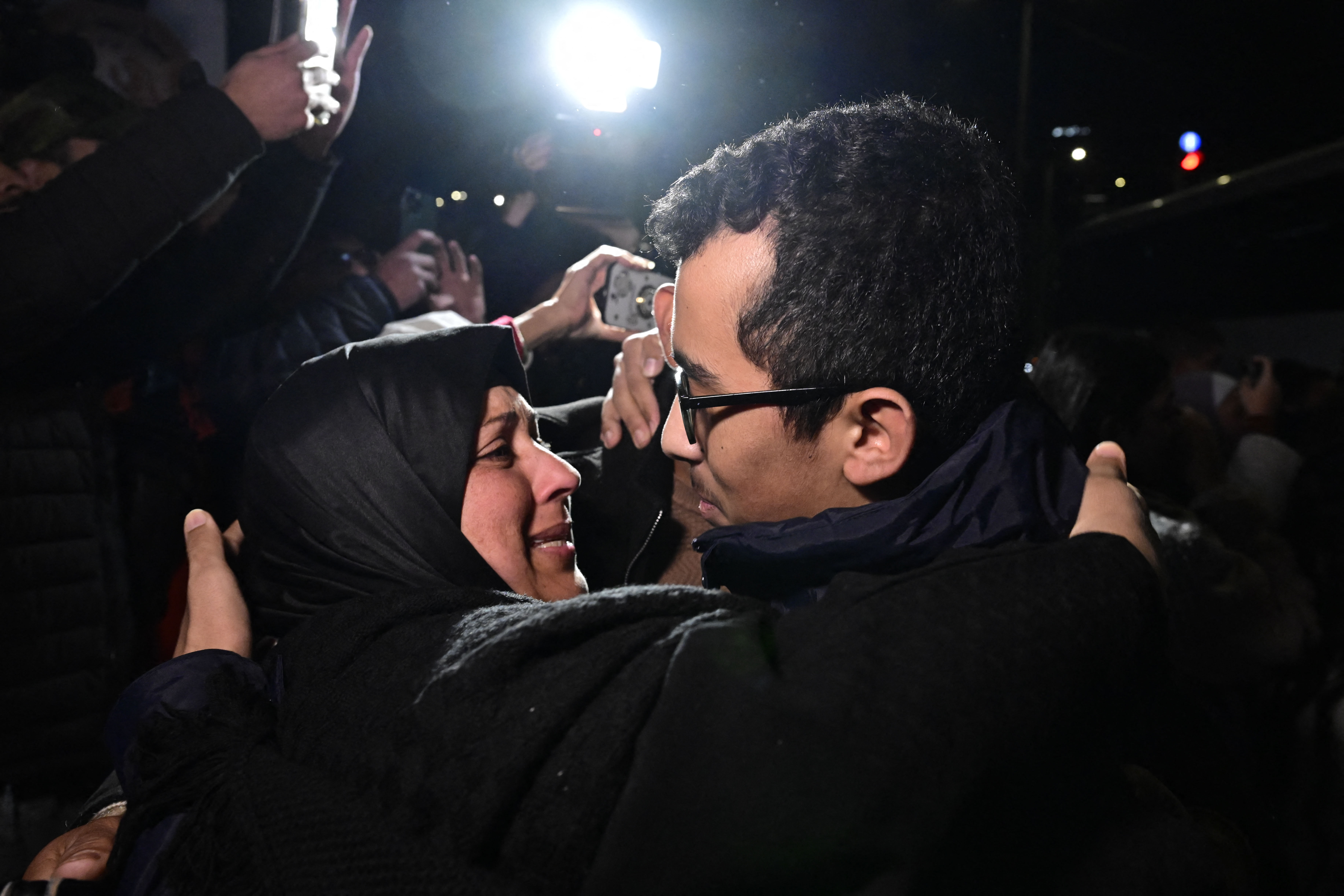 A newly released prisoner (R) greets a relative during a welcome ceremony following the release of Palestinian prisoners from Israeli jails in exchange for Israeli hostages held in Gaza by Hamas.