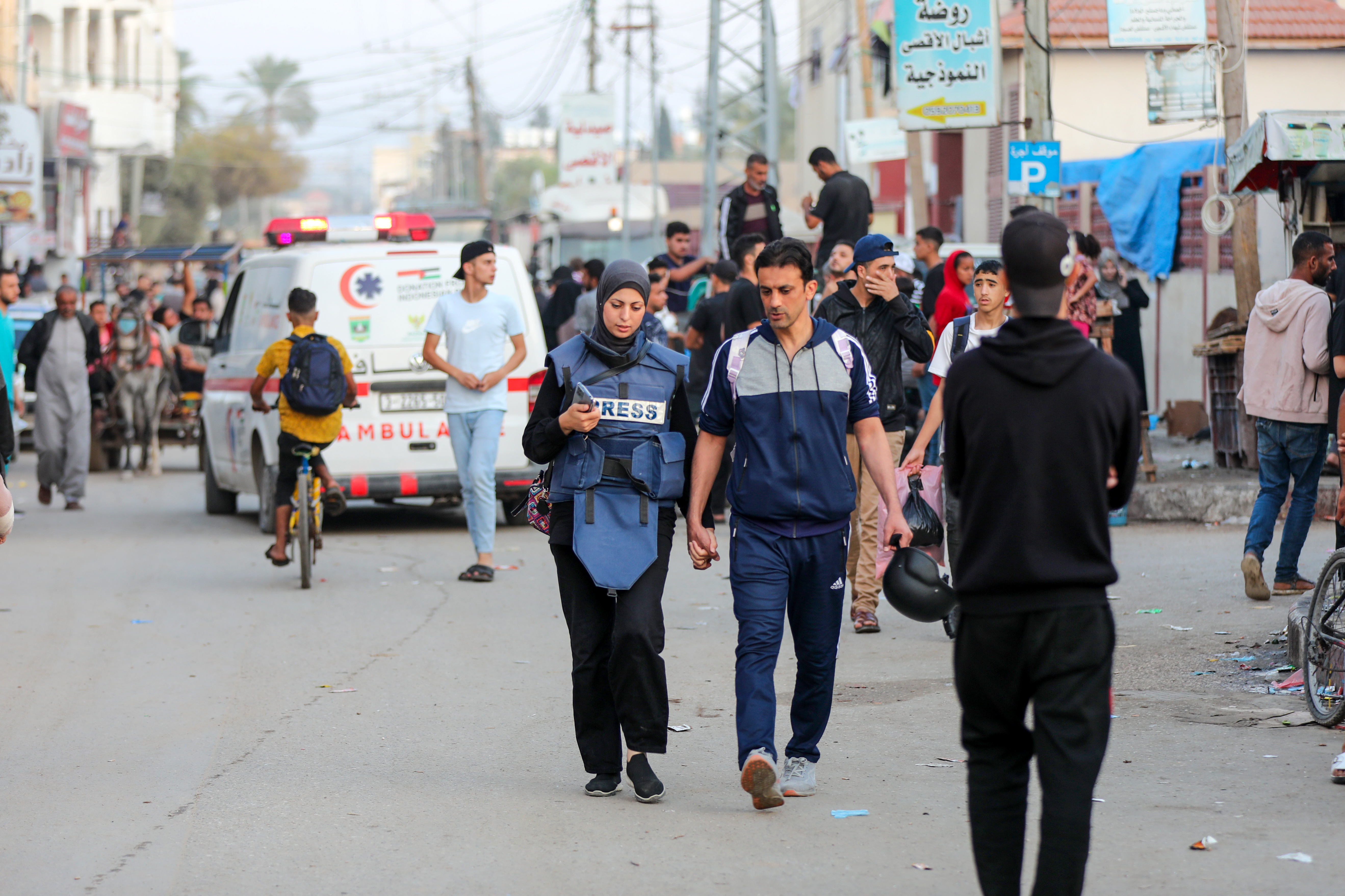 Khawla and her husband Baher walk back after she finishes work