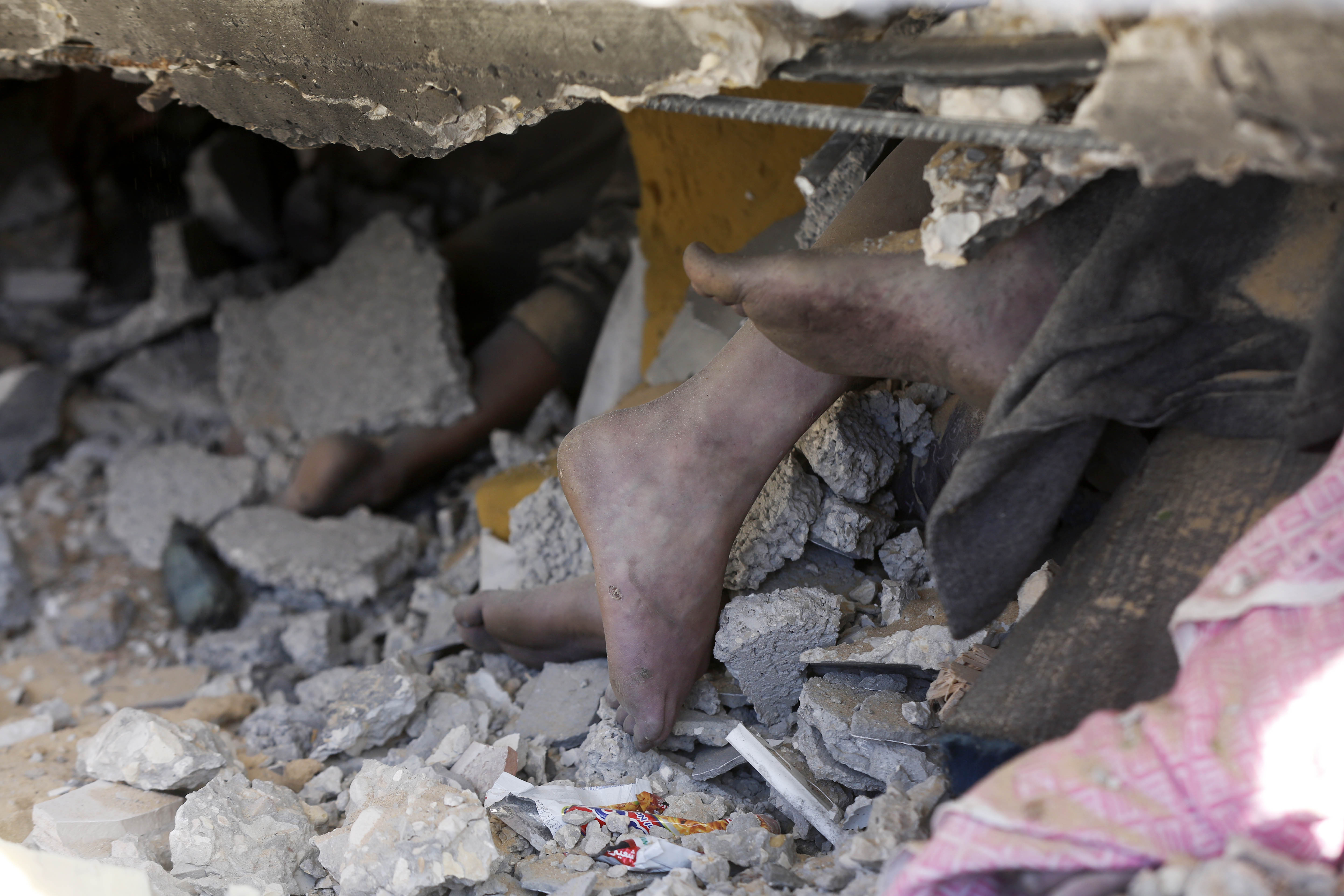 Lifeless bodies are being removed from the rubble of the building that collapsed following an Israeli attack on a house belonging to the al-Haj family at the Nuseirat refugee camp in Deir al-Balah, Gaza.