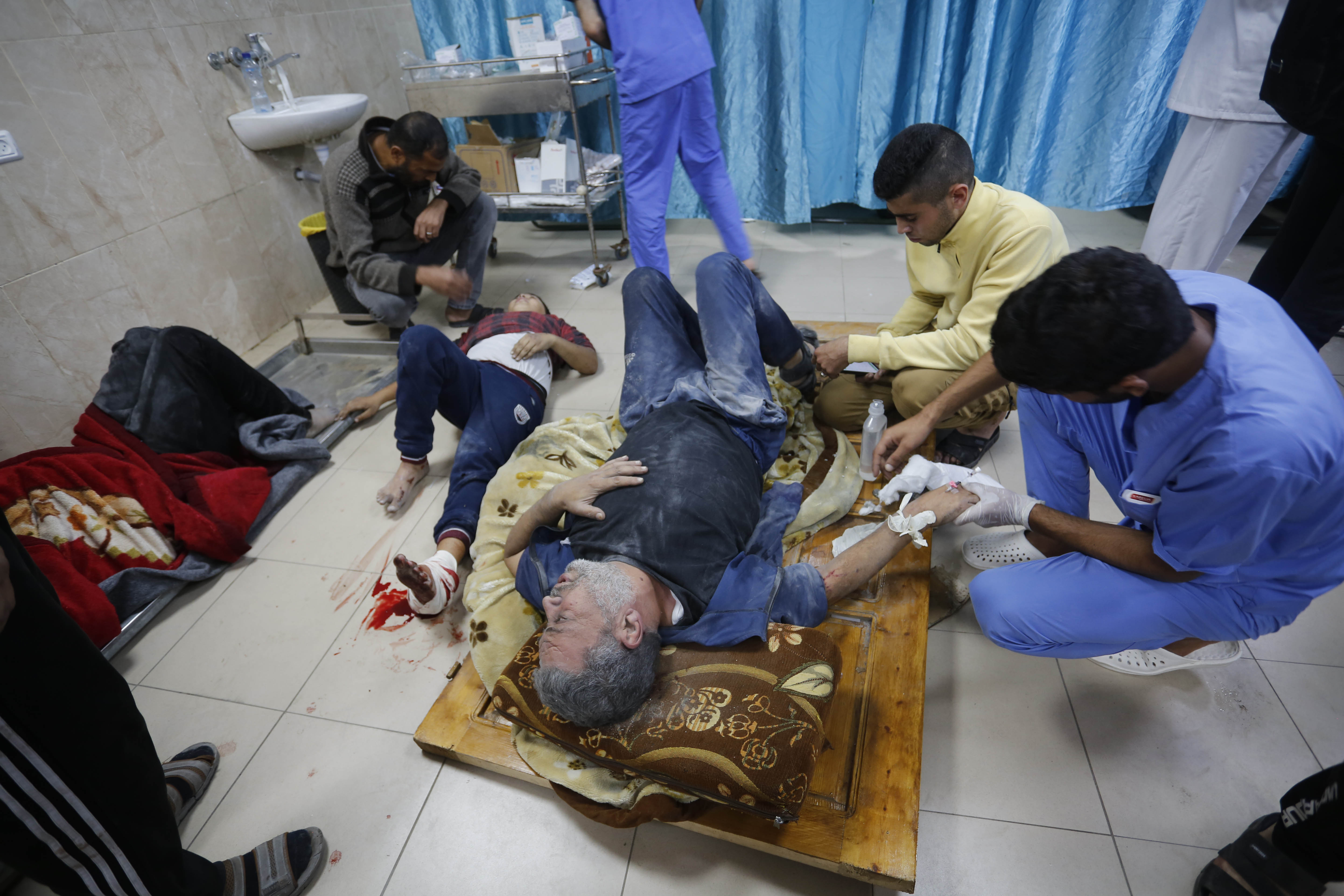 Doctors examine the Palestinians, including children injured as a result of the attacks of the Israeli army at Al-Aqsa Martyrs Hospital in Deir al-Balah, Gaza.