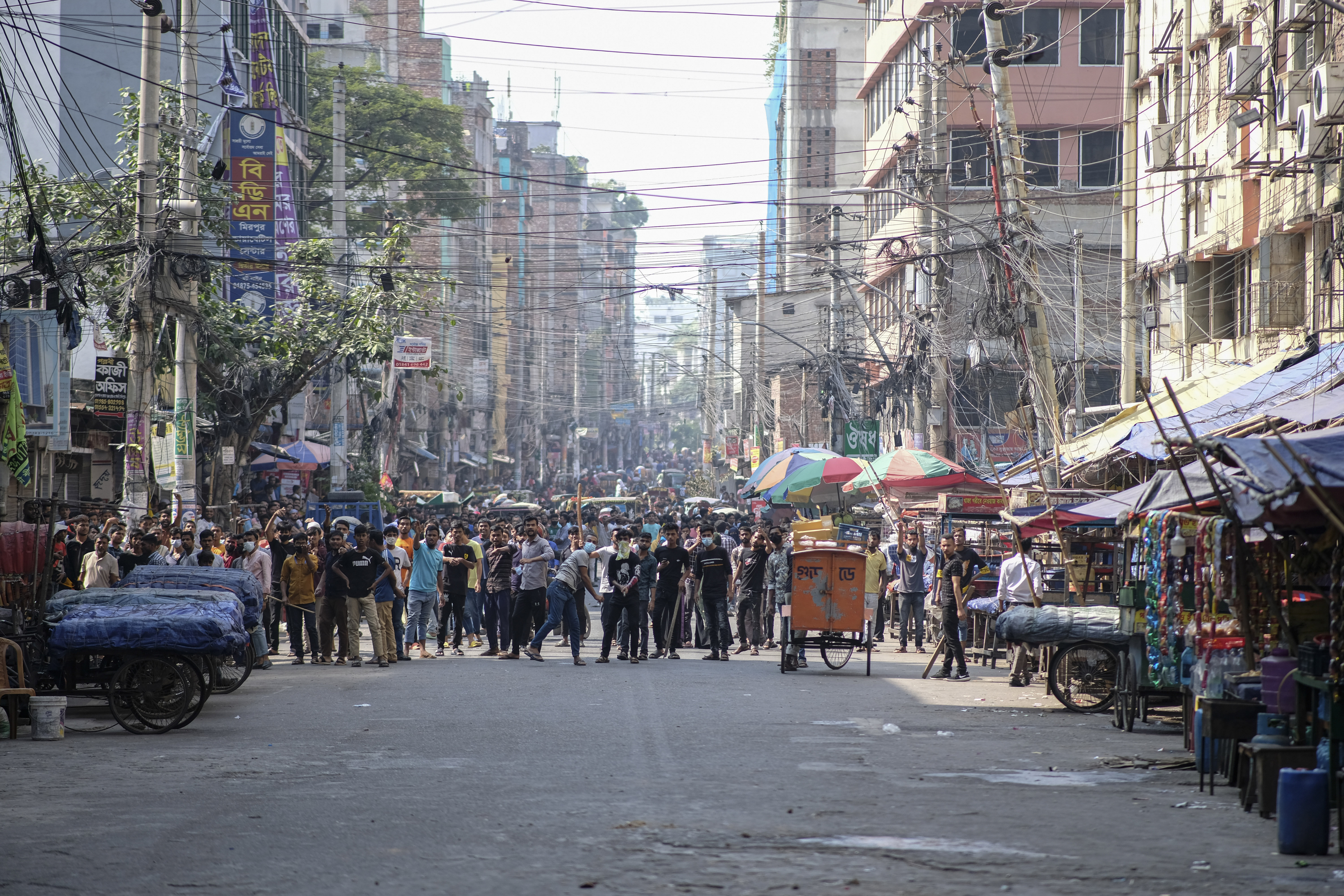 Bangladeshi garment factory workers demanding better wages block traffic and clash with police at Dhaka-Mirpur area in Bangladesh.
