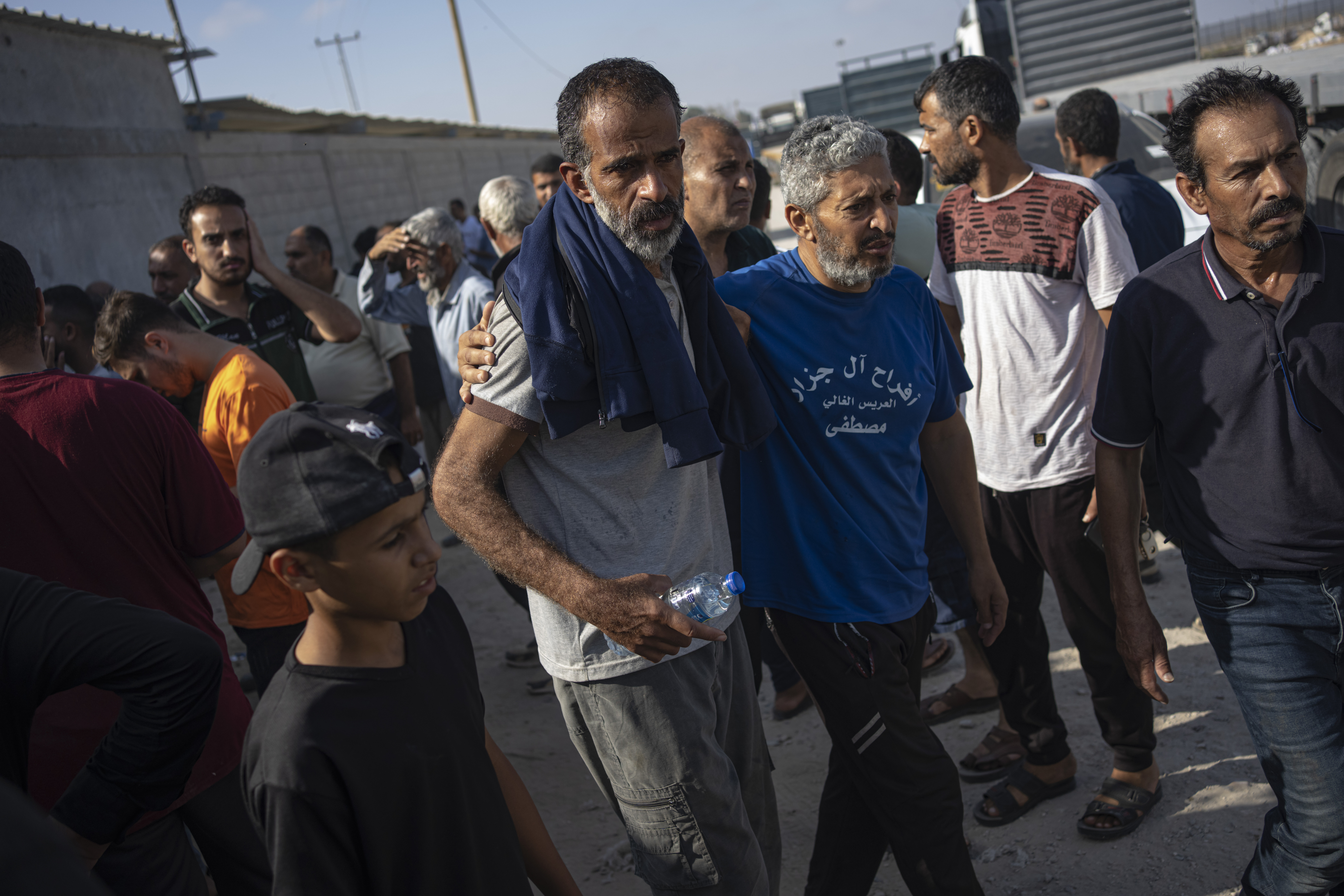 Palestinian day laborers in Israel arrive in the Gaza Strip at the Kerem Shalom crossing brought by the Israeli authorities.