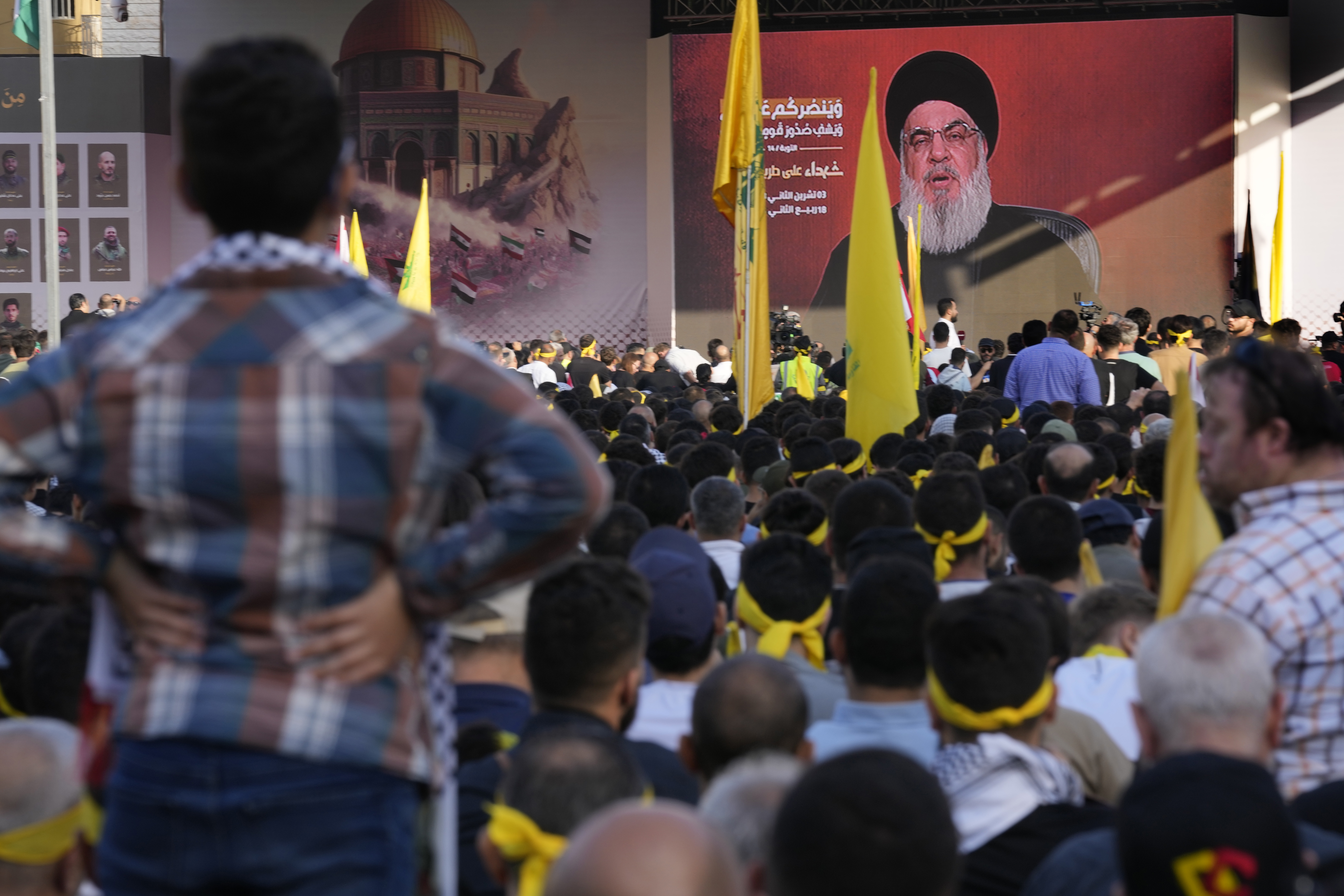Supporters of the Iranian-backed Hezbollah group listen to Hezbollah leader Sayyed Hassan Nasrallah, who addresses a speech via a video link, during a rally to commemorate Hezbollah fighters who killed in South Lebanon last few weeks while fighting against the Israeli forces, in Beirut, Lebanon.