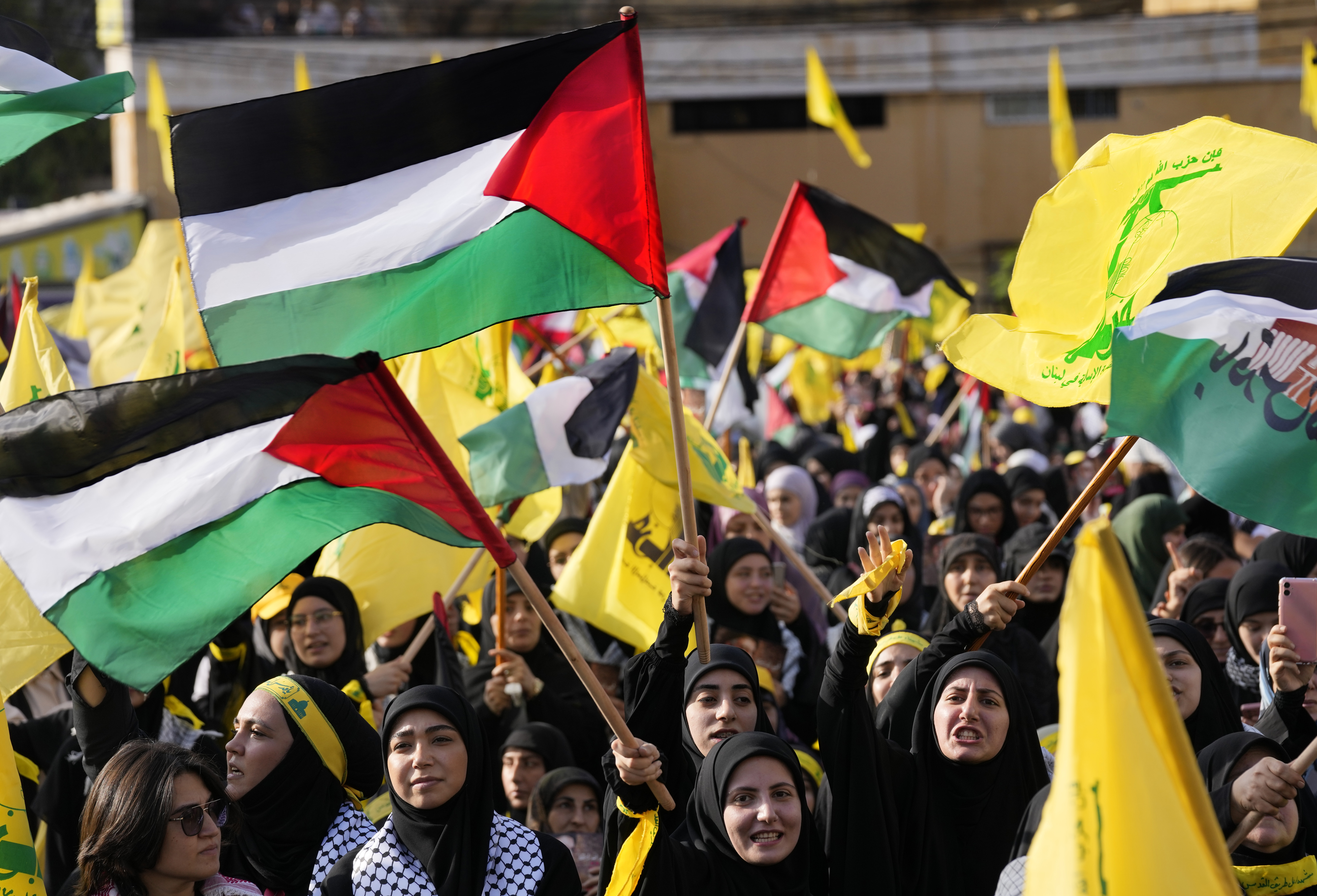 Supporters of the Iranian-backed Hezbollah group shout slogans and wave Palestinian and their group flags, as they wait the speech of Hezbollah leader Sayyed Hassan Nasrallah, during a rally to commemorate Hezbollah fighters who were killed in South Lebanon last few weeks while fighting against the Israeli forces, in Beirut, Lebanon.