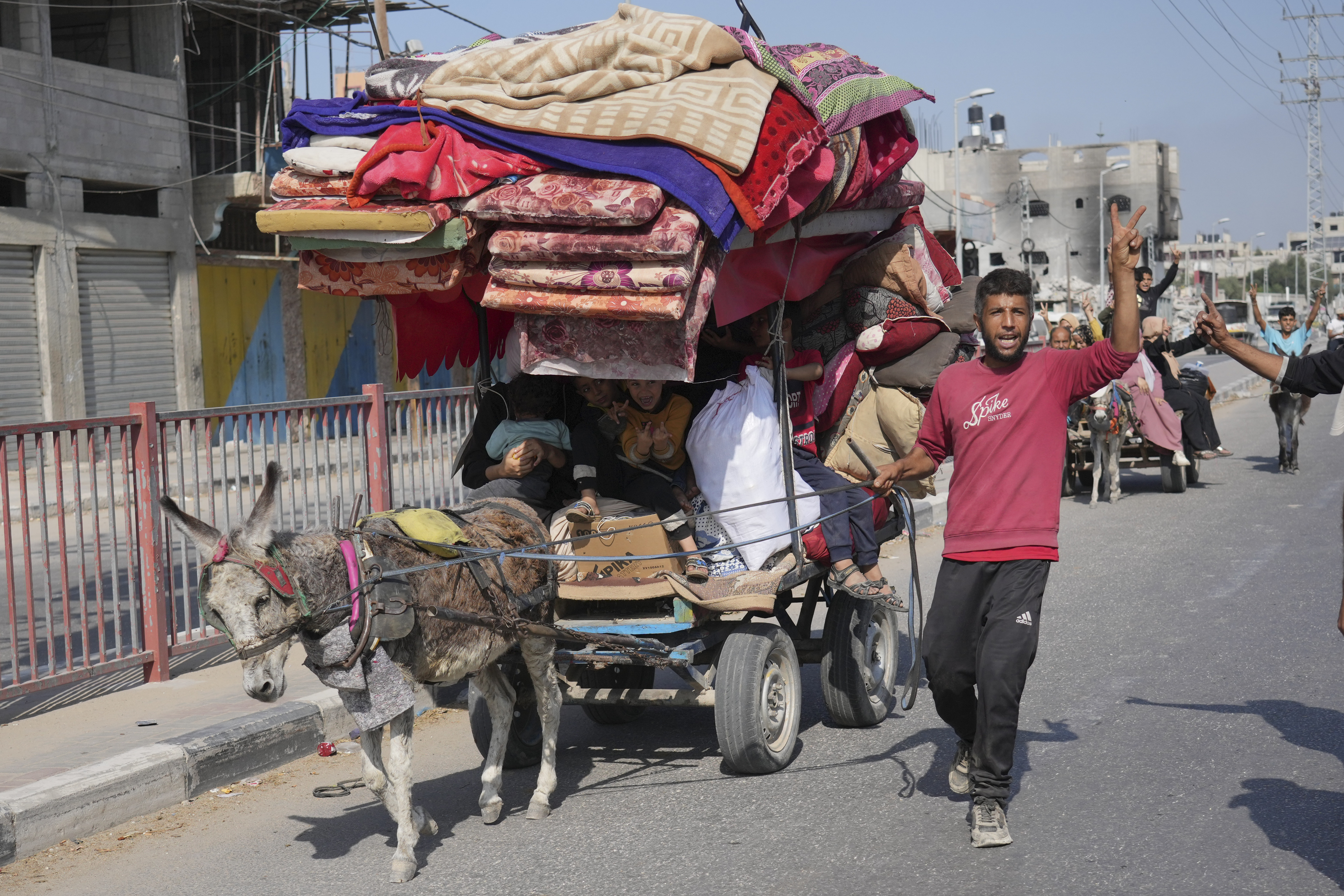 Palestinians flee the southern Gaza Strip on Salah al-Din street in Bureij on Sunday, Nov. 5