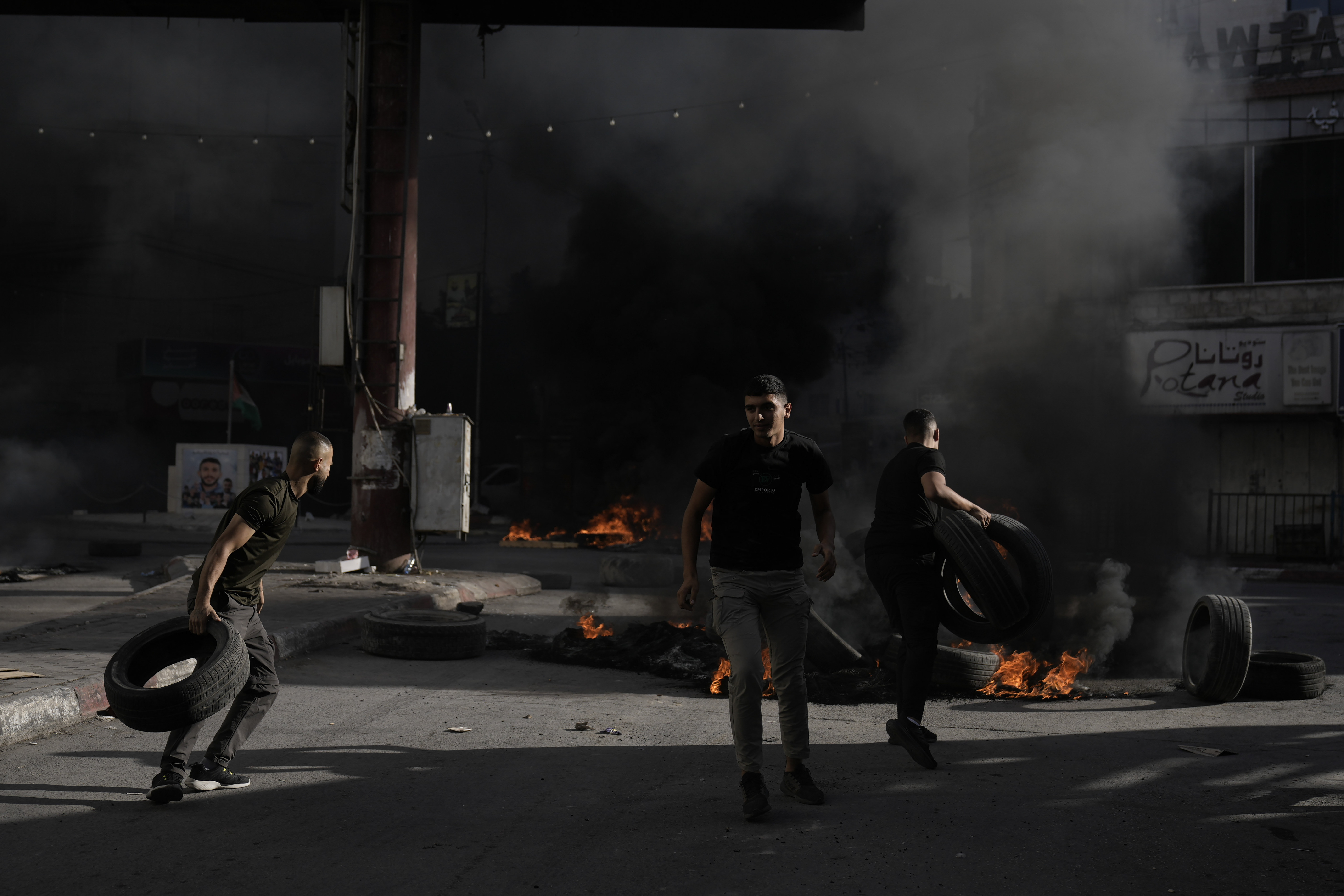 Palestinian demonstrators burn tries during clashes with Israeli forces in Jenin refugee camp in the West Bank.