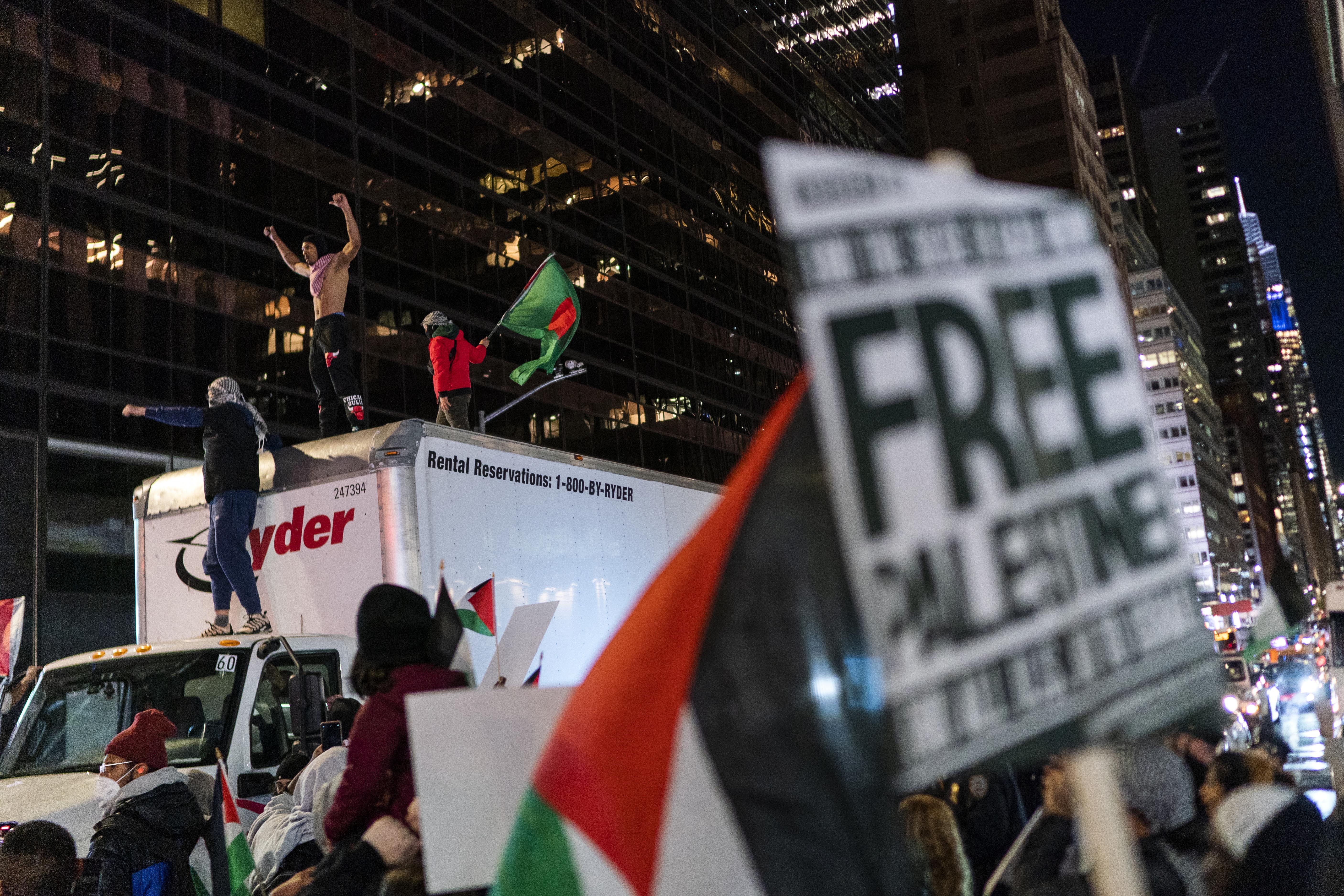 Pro-Palestinian demonstrators climb a truck while they march calling for a cease fire in Gaza, Friday, Nov. 10, 2023, in New York.