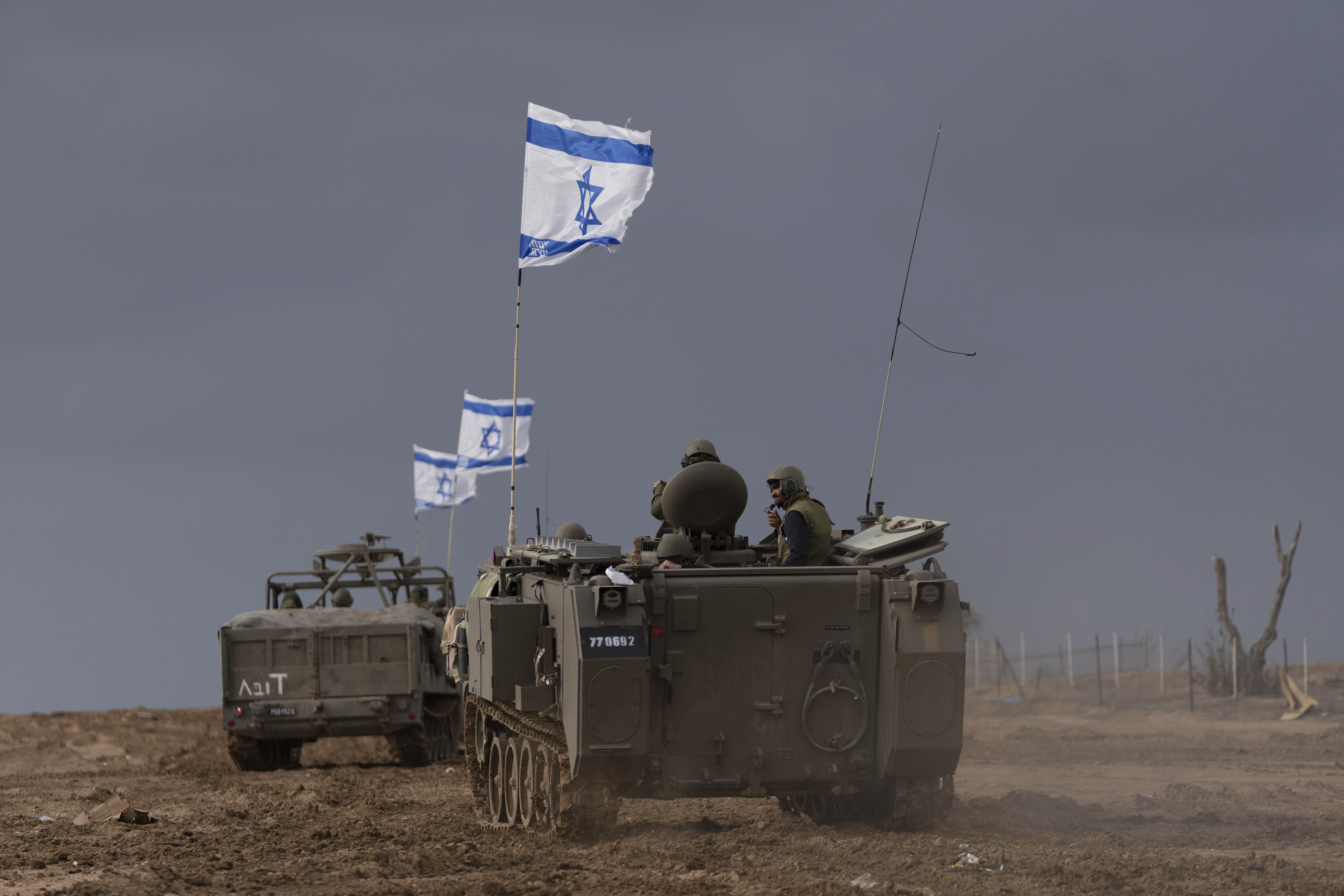 Israeli soldiers manoeuver armored military vehicles along Israel's border with the Gaza Strip, in southern Israel, on Monday, Nov. 20, 2023 [AP Photo/Ohad Zwigenberg]
