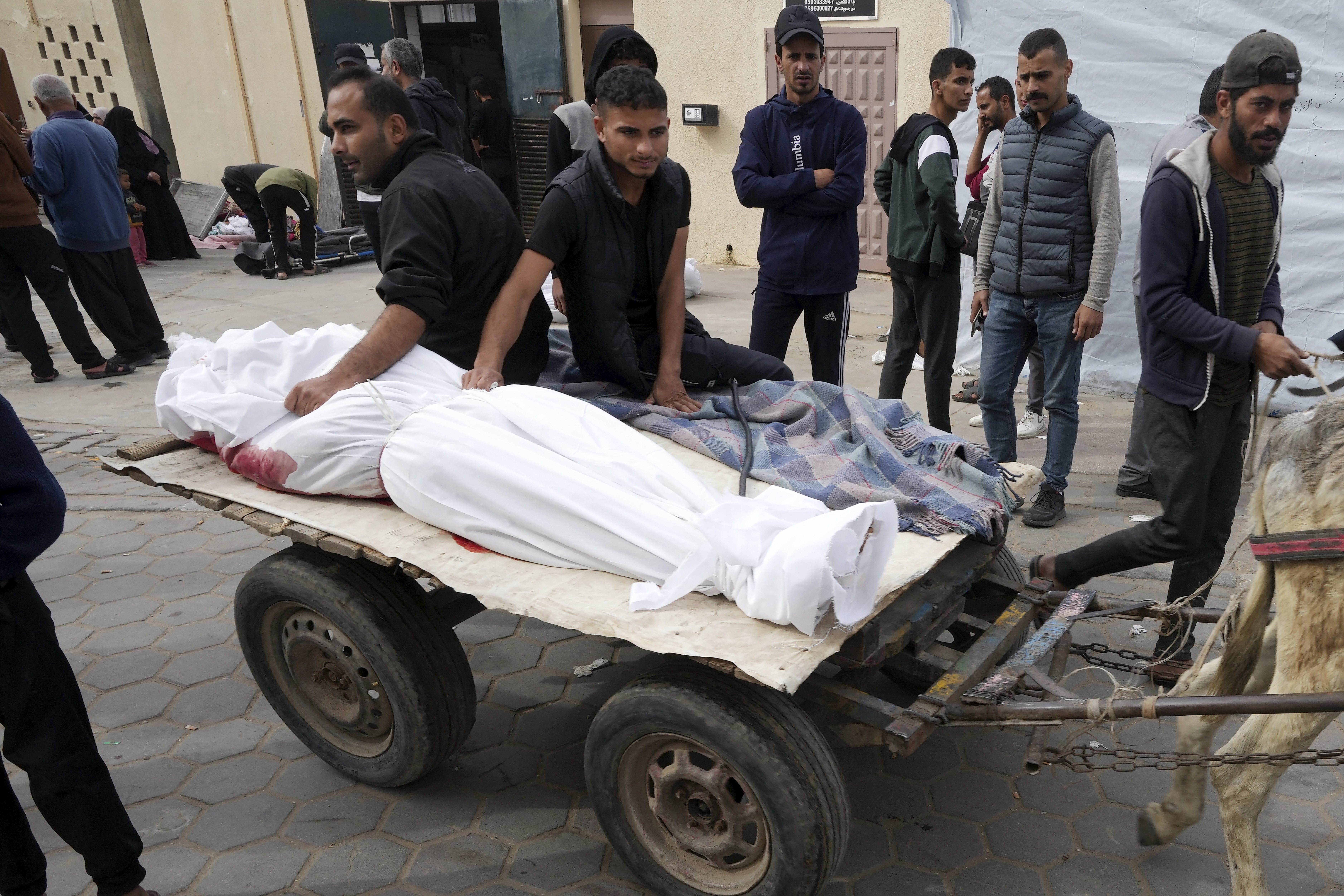 Palestinians bring the body of a relative killed in The Israeli bombardment to a morgue in Deir al Balah, Gaza Strip.