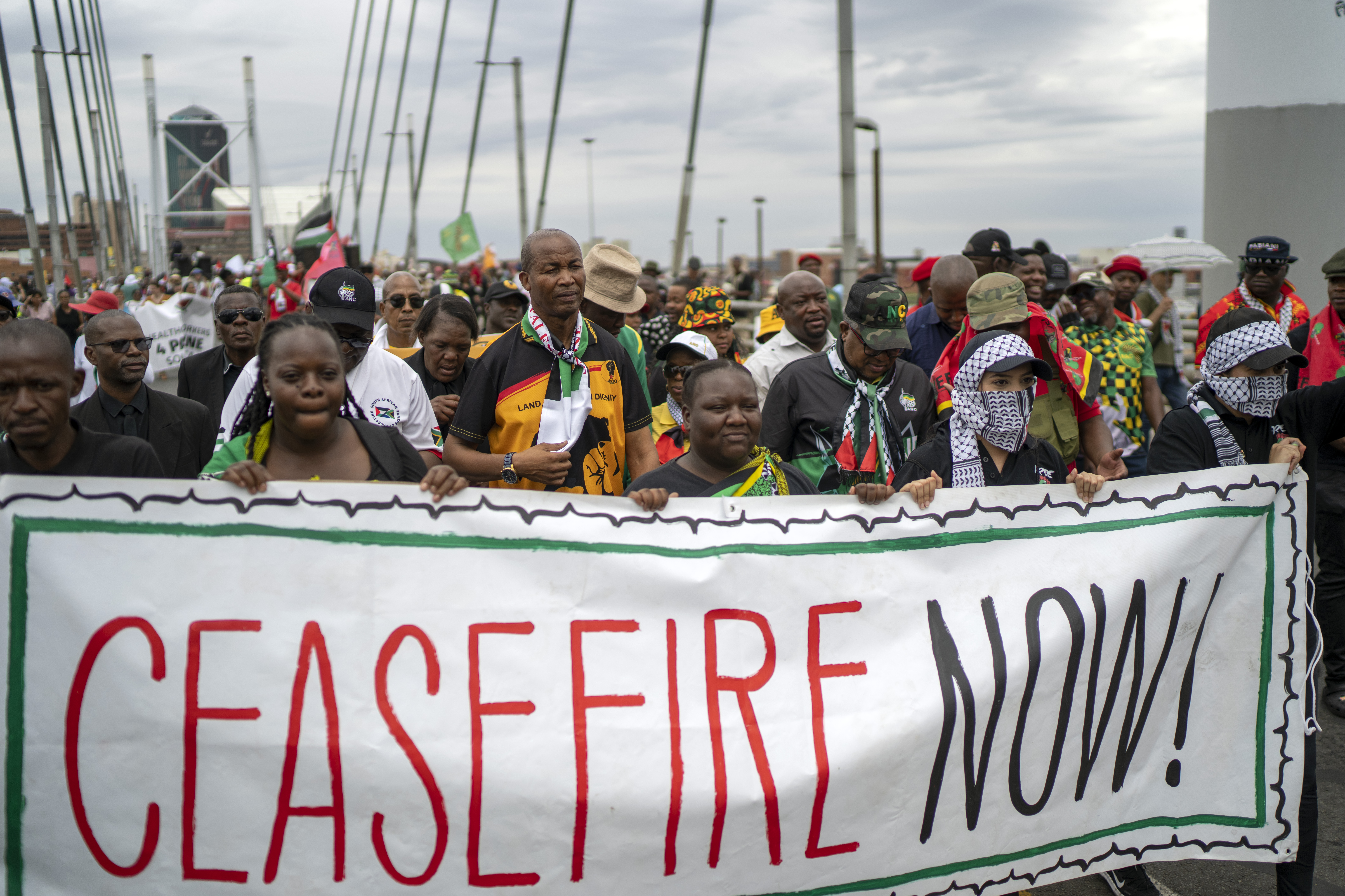 Pro-Palestinian demonstrators march across the Mandela Bridge downtown Johannesburg