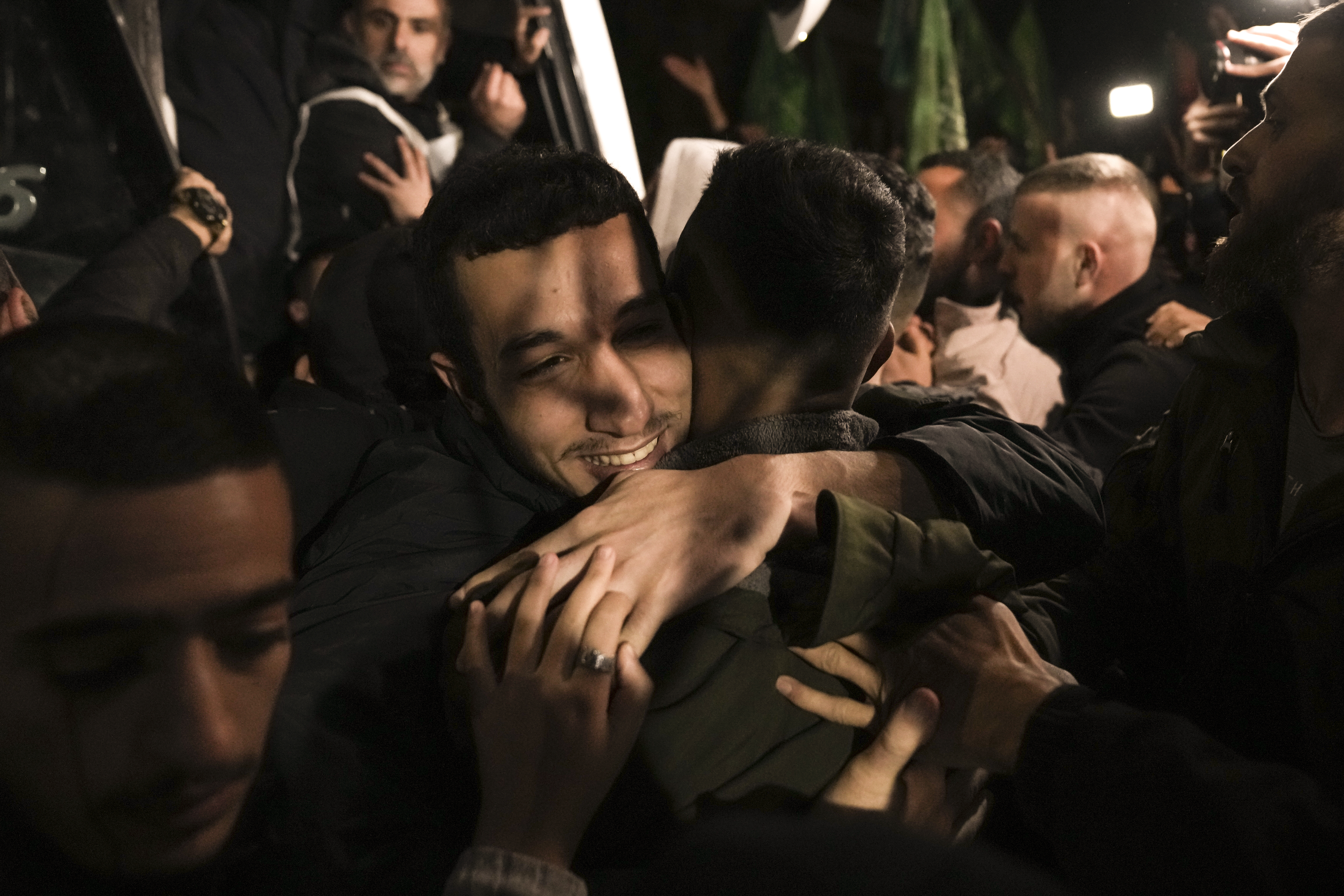A man smiles as he is welcomed after being released from prison by Israel, in the West Bank town of Ramallah.