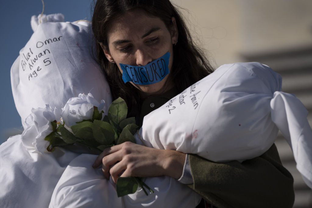 Activists take part during a silent demonstration at the Capitol Building stairs to demand a ceasefire and an urgent humanitarian action for Gaza and the Palestinian people.