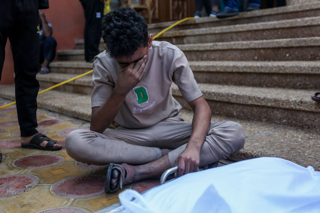 People mourn as they collect the bodies of Palestinians killed in Israeli air raids in Khan Yunis, Gaza.