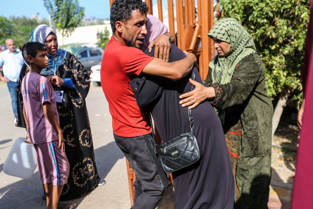 People mourn as they collect the bodies of Palestinians killed in Israeli air raids on November 5, 2023 in Khan Yunis, Gaza.