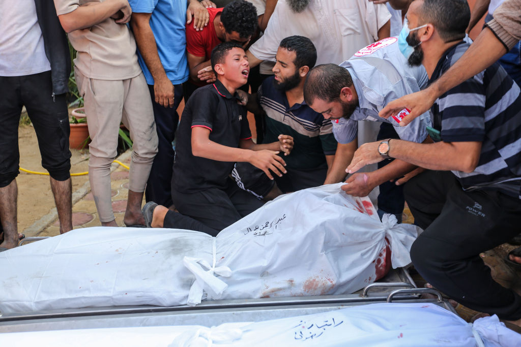 People mourn as they collect the bodies of Palestinians killed in Israeli air raids on November 5, 2023 in Khan Yunis, Gaza.